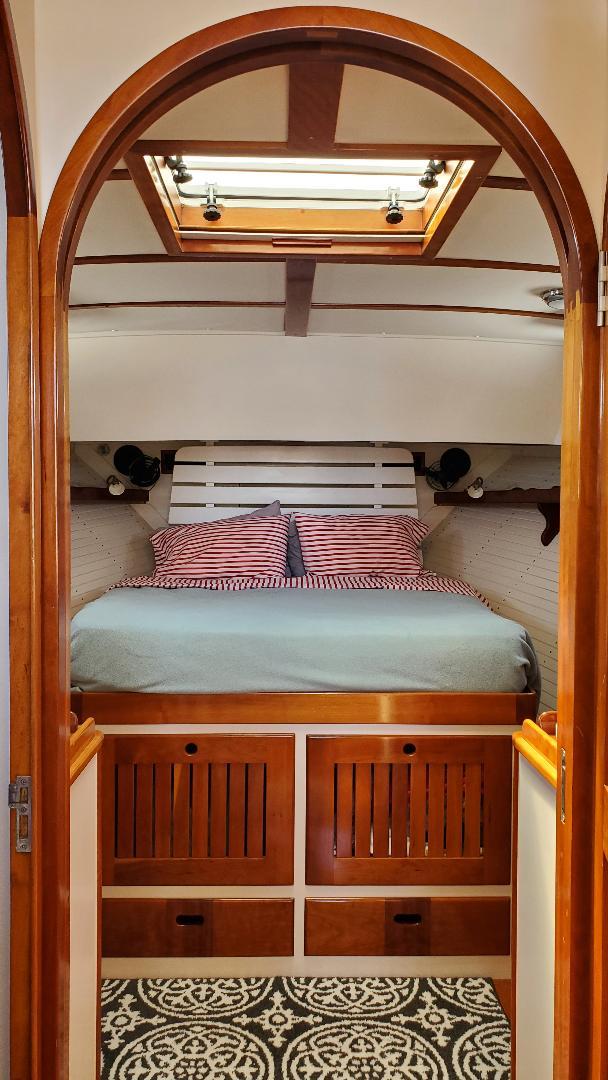 Cozy cabin interior of 1997 Lyman-Morse Custom Flybridge with wood accents and skylight.