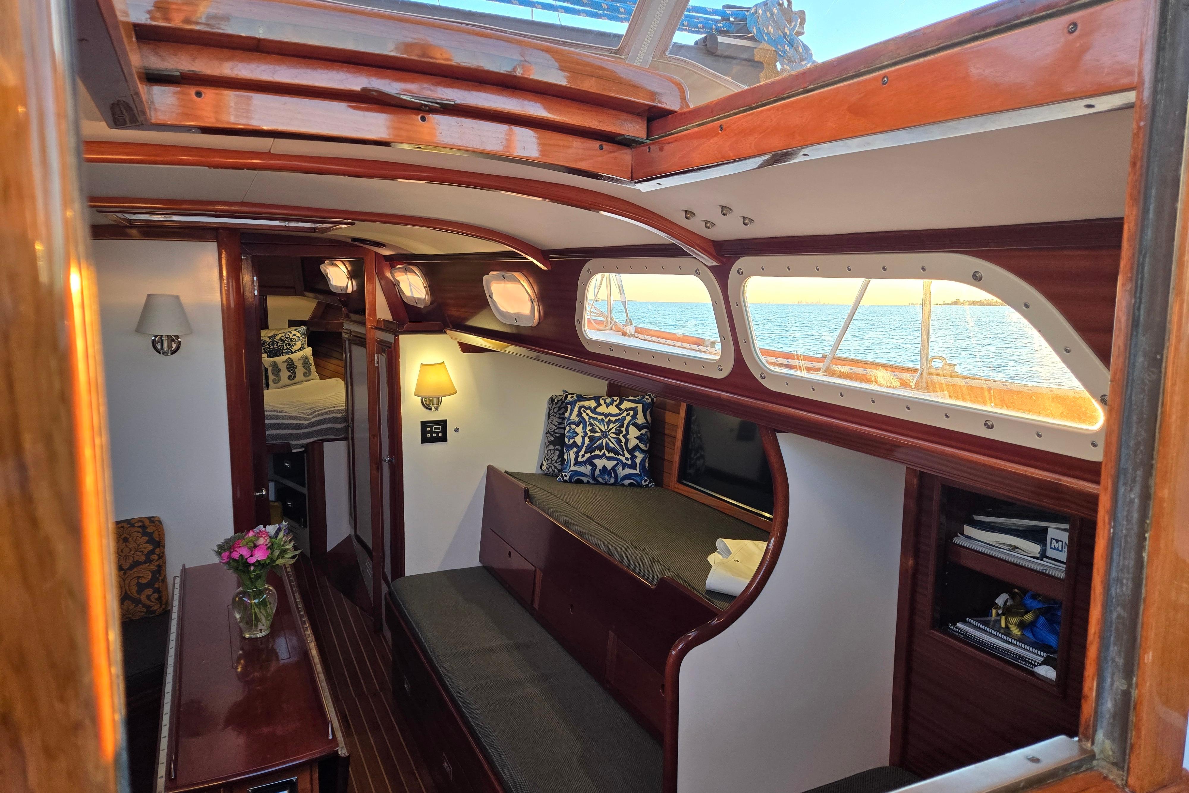 Interior of a 1970 Hinckley Bermuda 40 sailboat with elegant wood finish and cozy seating.