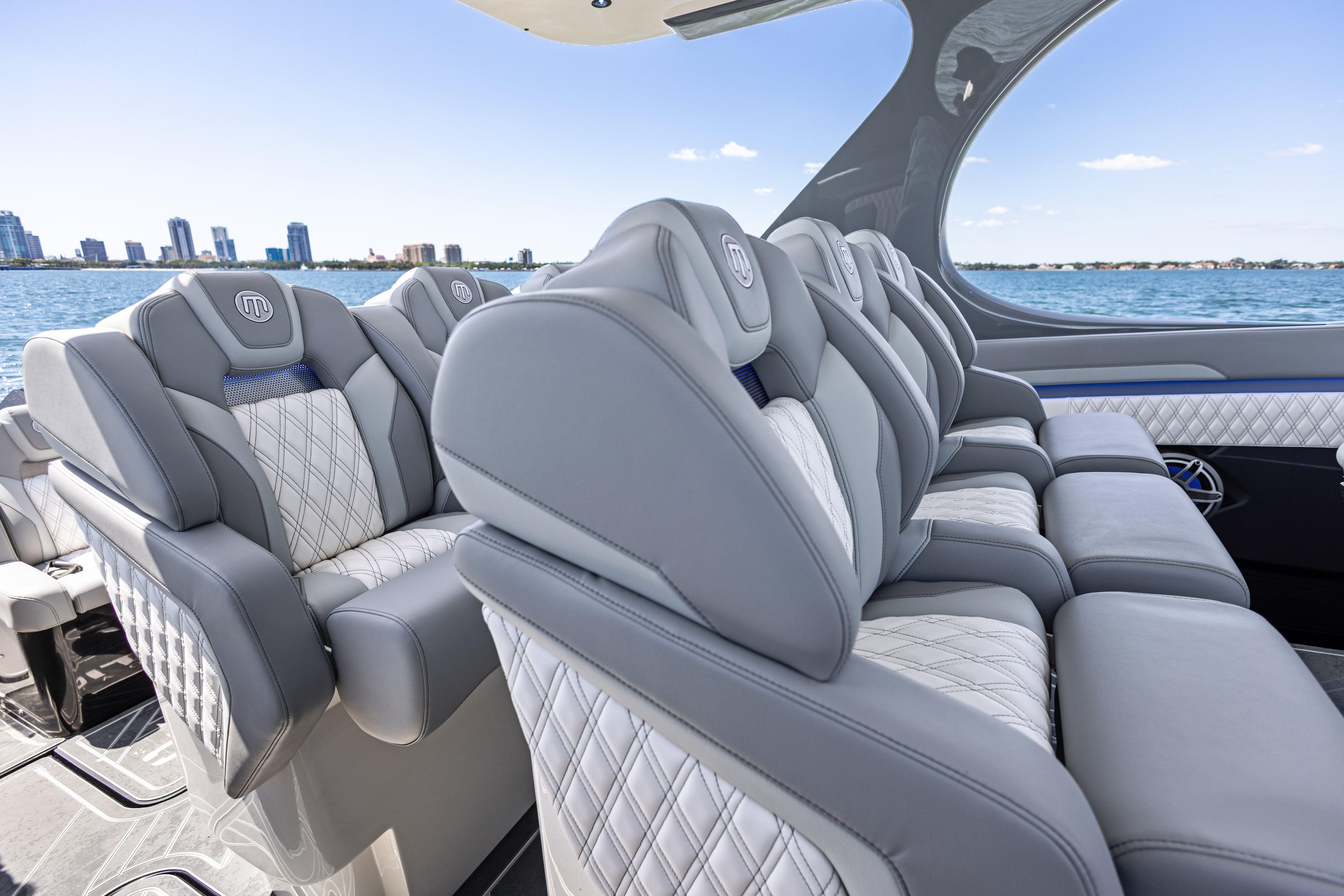 Luxurious seating on 2026 Mystic Powerboats M4200, with city skyline and ocean view.