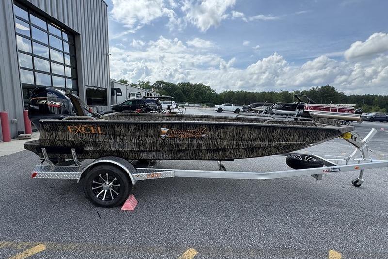 2026 Excel 183 Tomahawk boat on trailer, parked outdoors near a building.