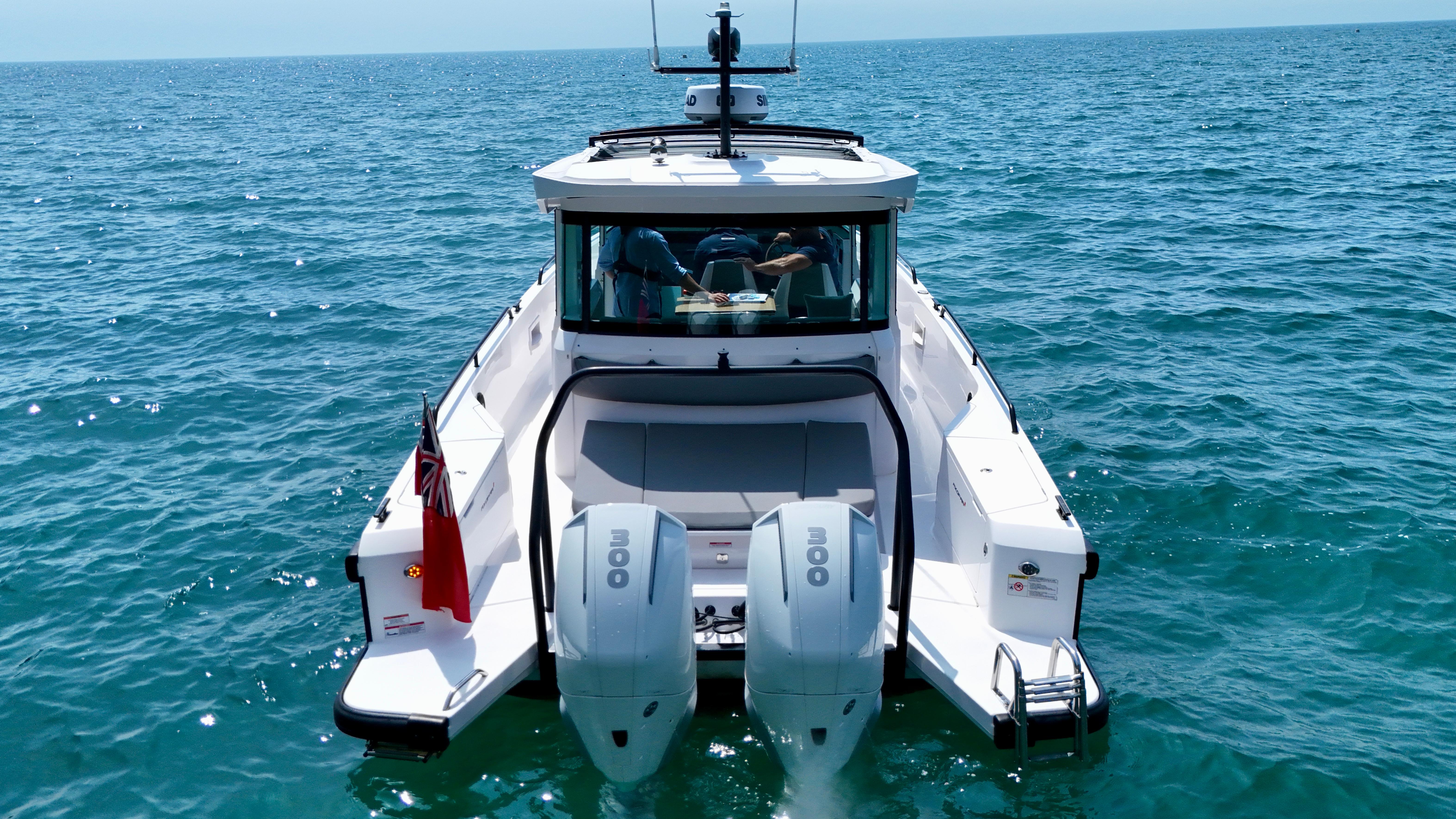 Axopar 37 Cross Cabin boat on open sea, rear view, 2020 model.