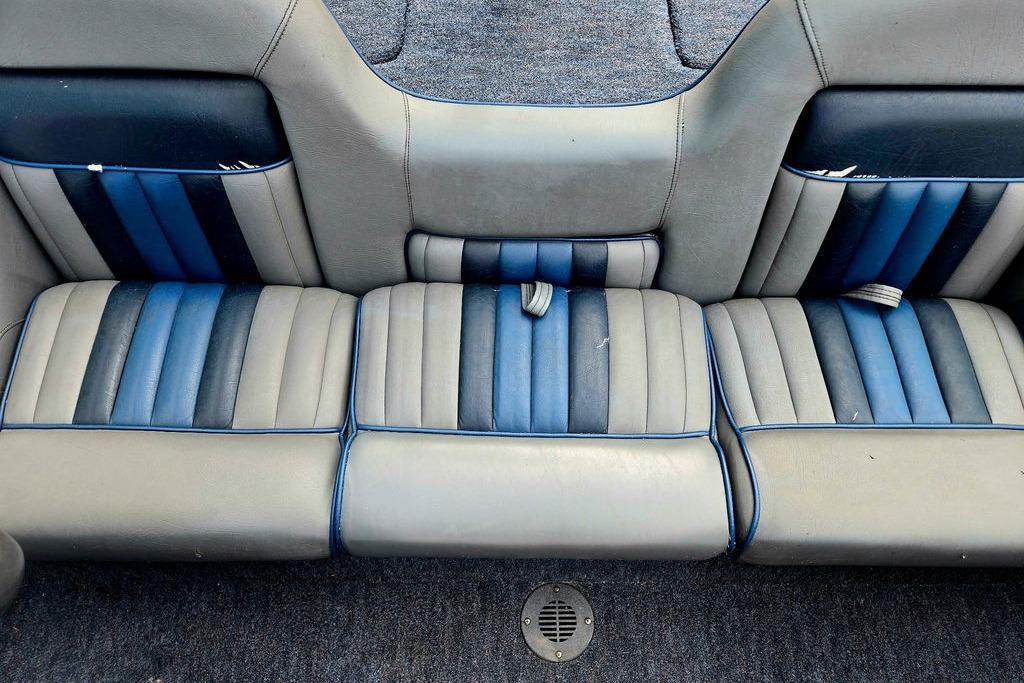 1996 Champion 181 SX boat interior with blue and gray striped seating.