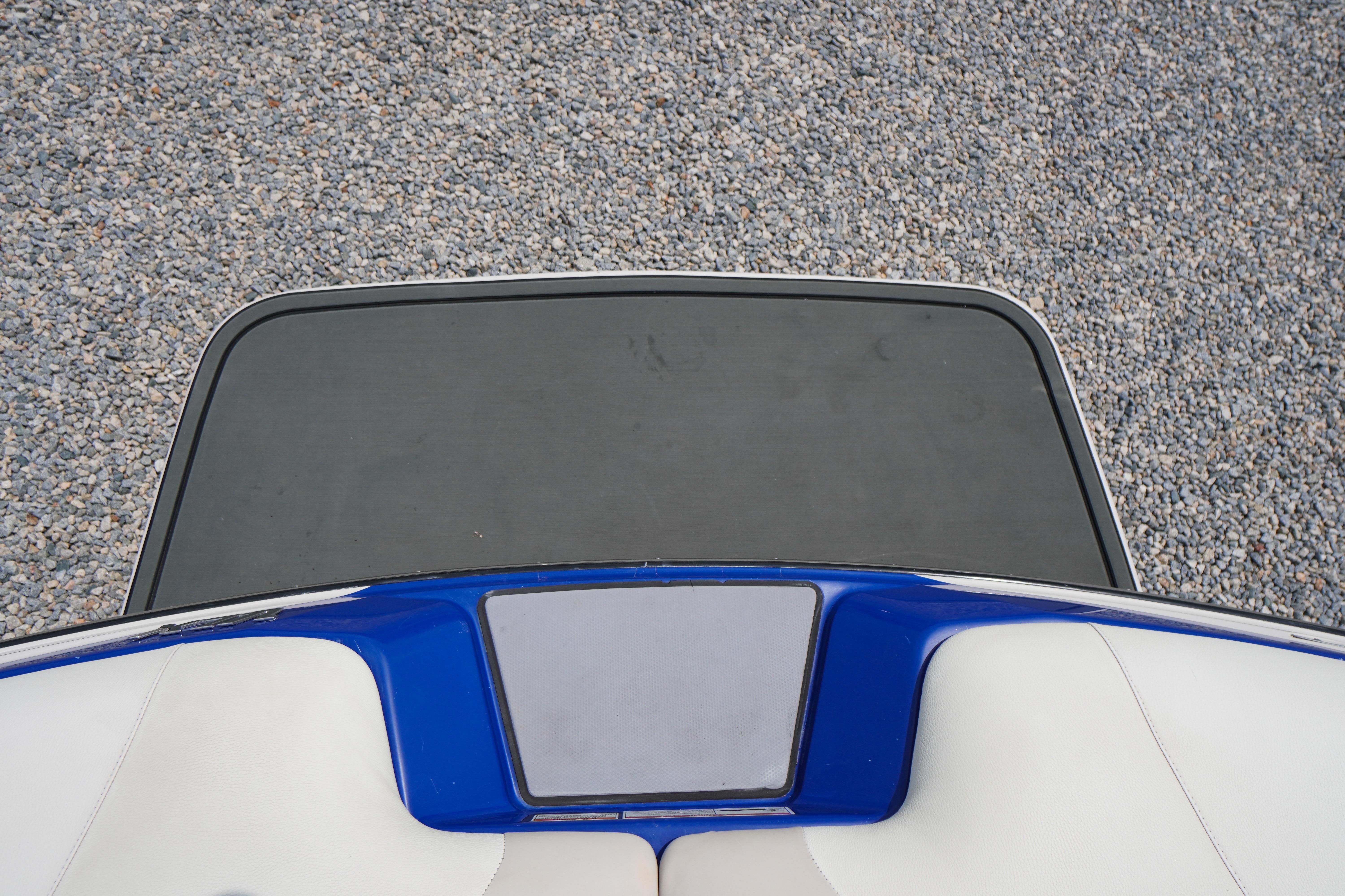 2011 Malibu Wakesetter 21 VLX swim platform on gravel background.