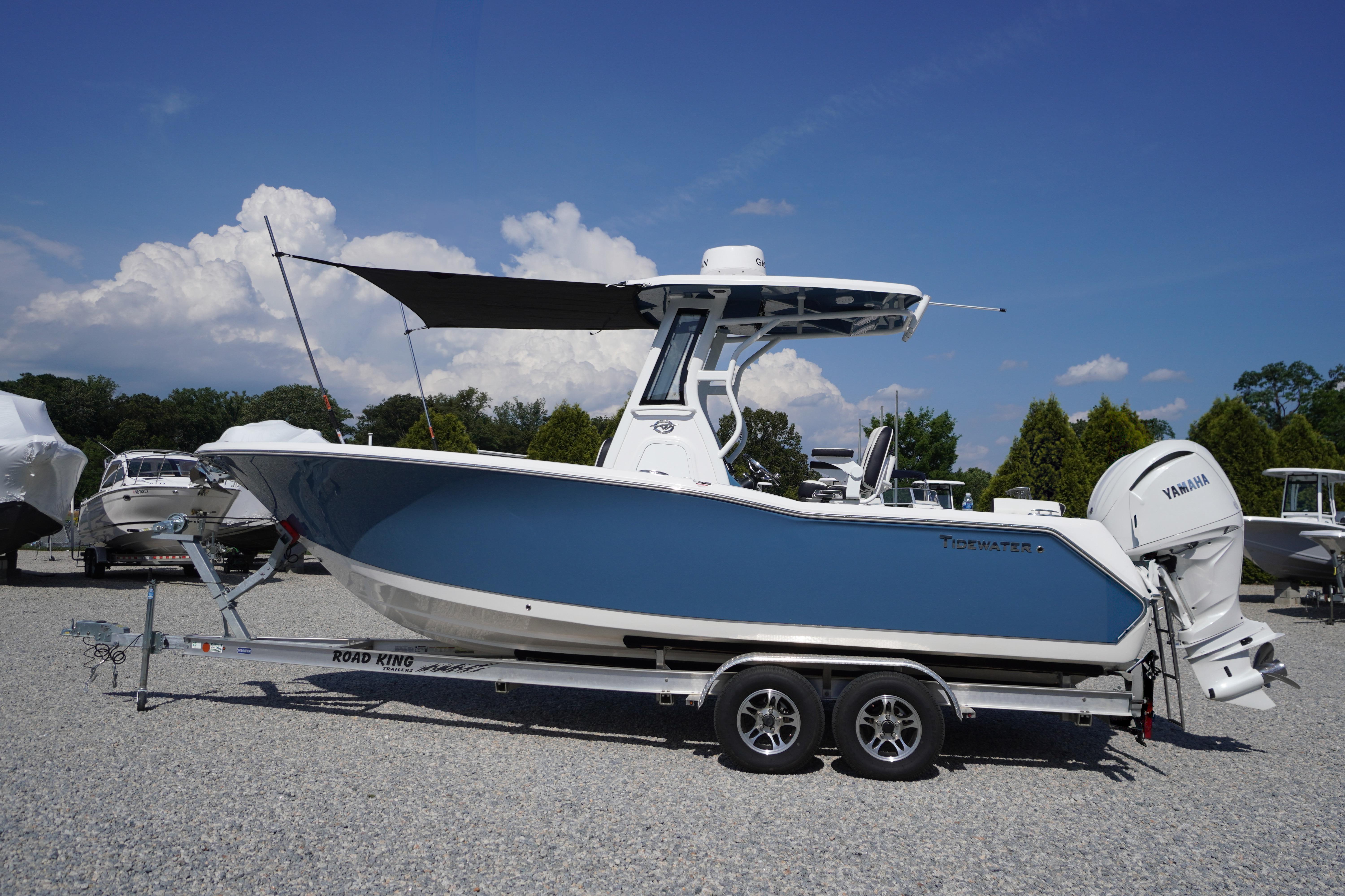 2025 Tidewater 232 SS boat on trailer, blue hull, Yamaha engine, sunny day.