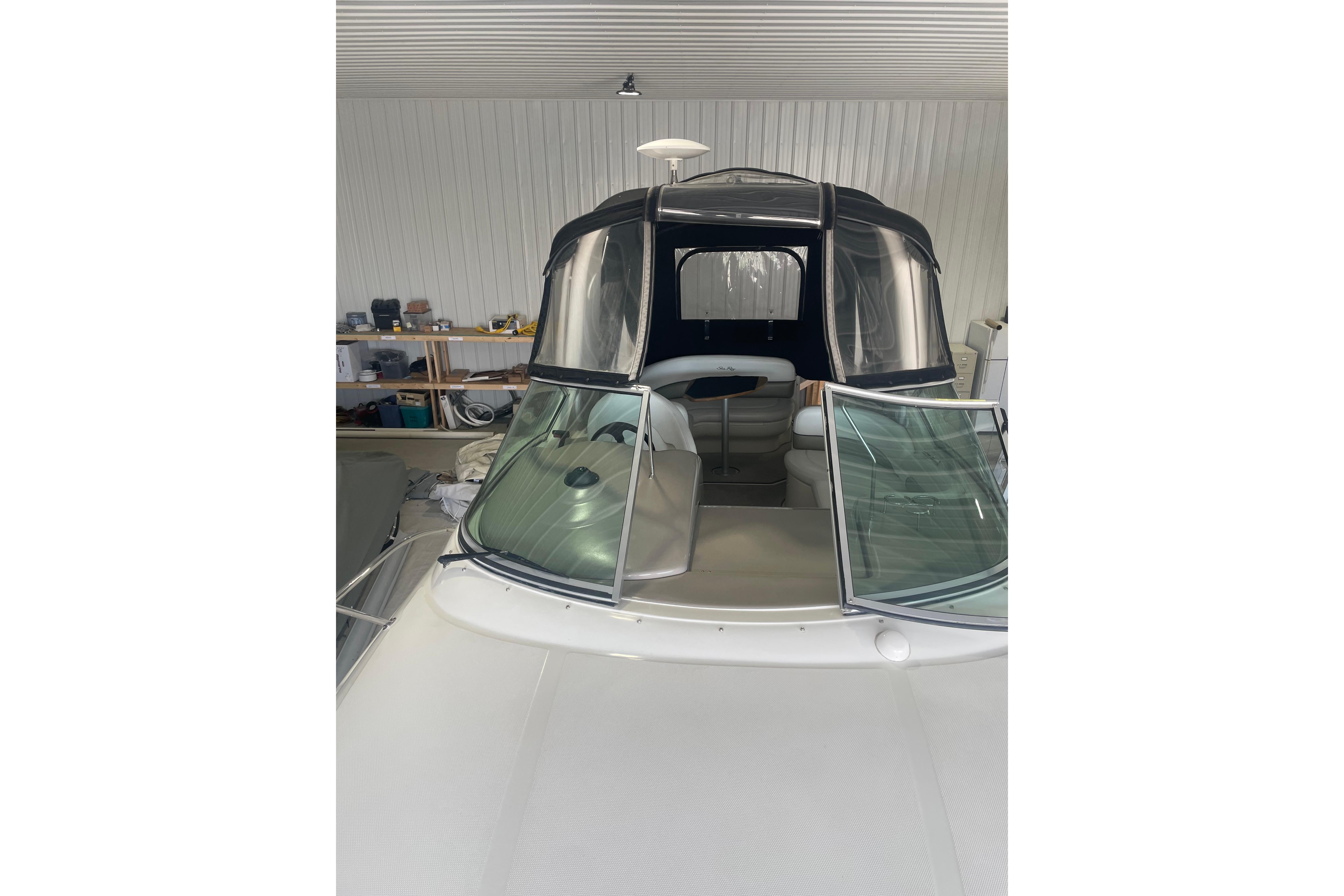 2006 Sea Ray Sundancer 260 boat in storage, featuring a sleek design and covered cockpit.