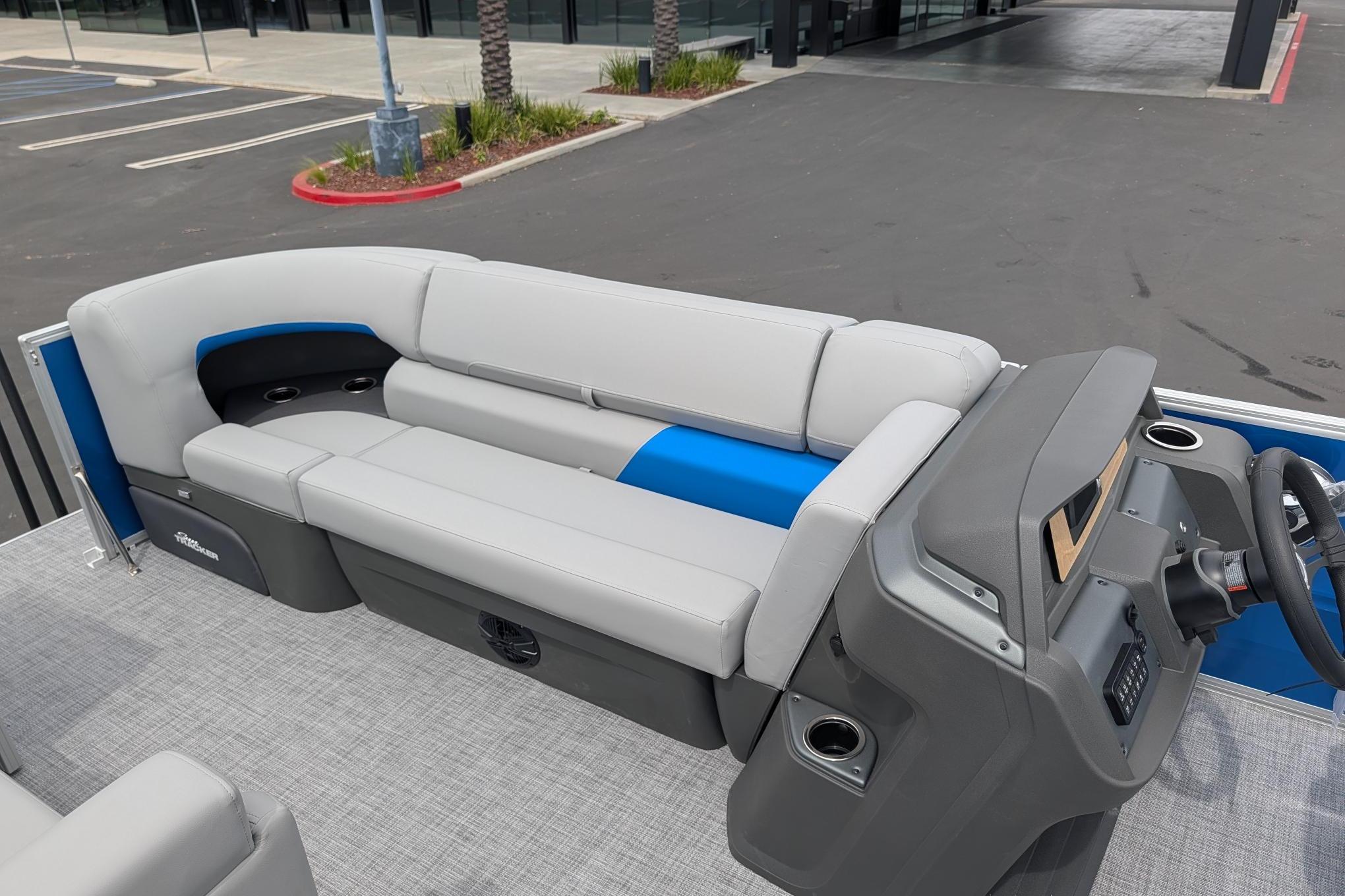 2026 Sun Tracker Party Barge 20 DLX interior with gray seating and modern helm.