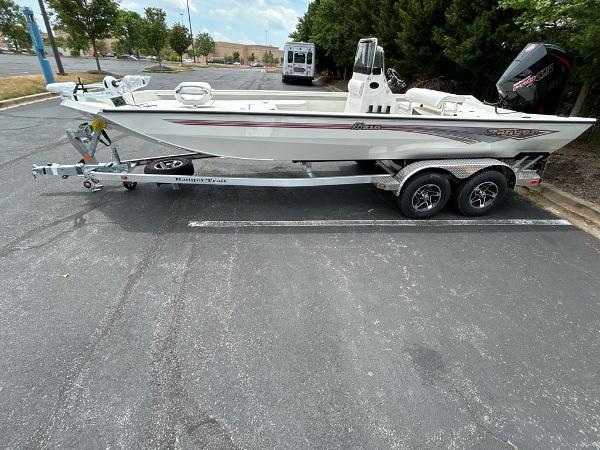 2024 Ranger RB210 boat on trailer in parking lot, side view.