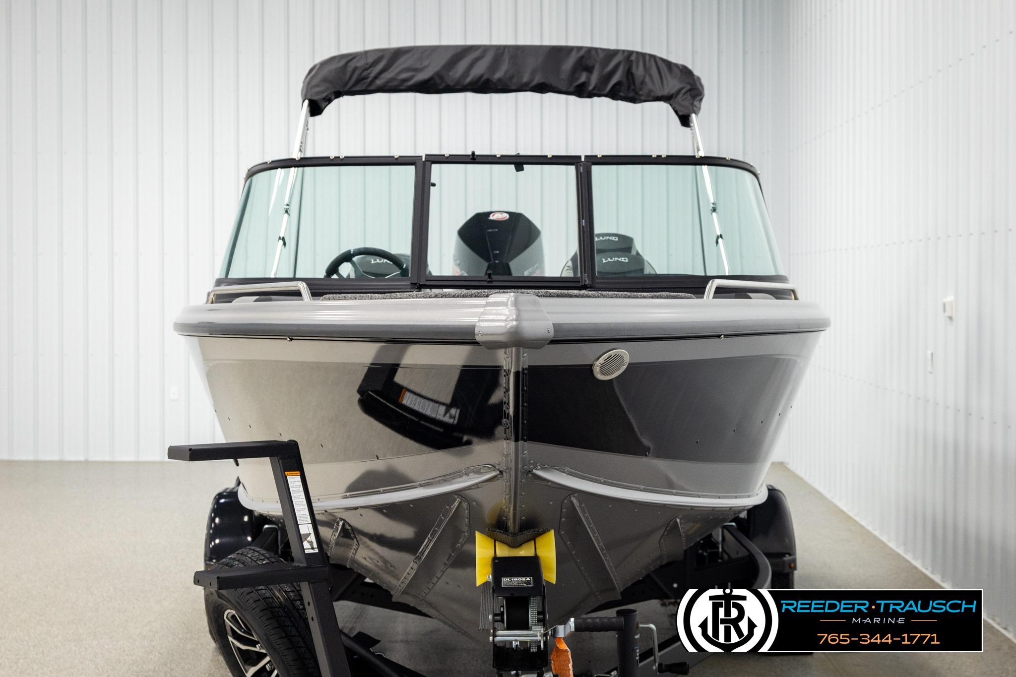Front view of a 2026 Lund 1975 Tyee boat in a showroom.