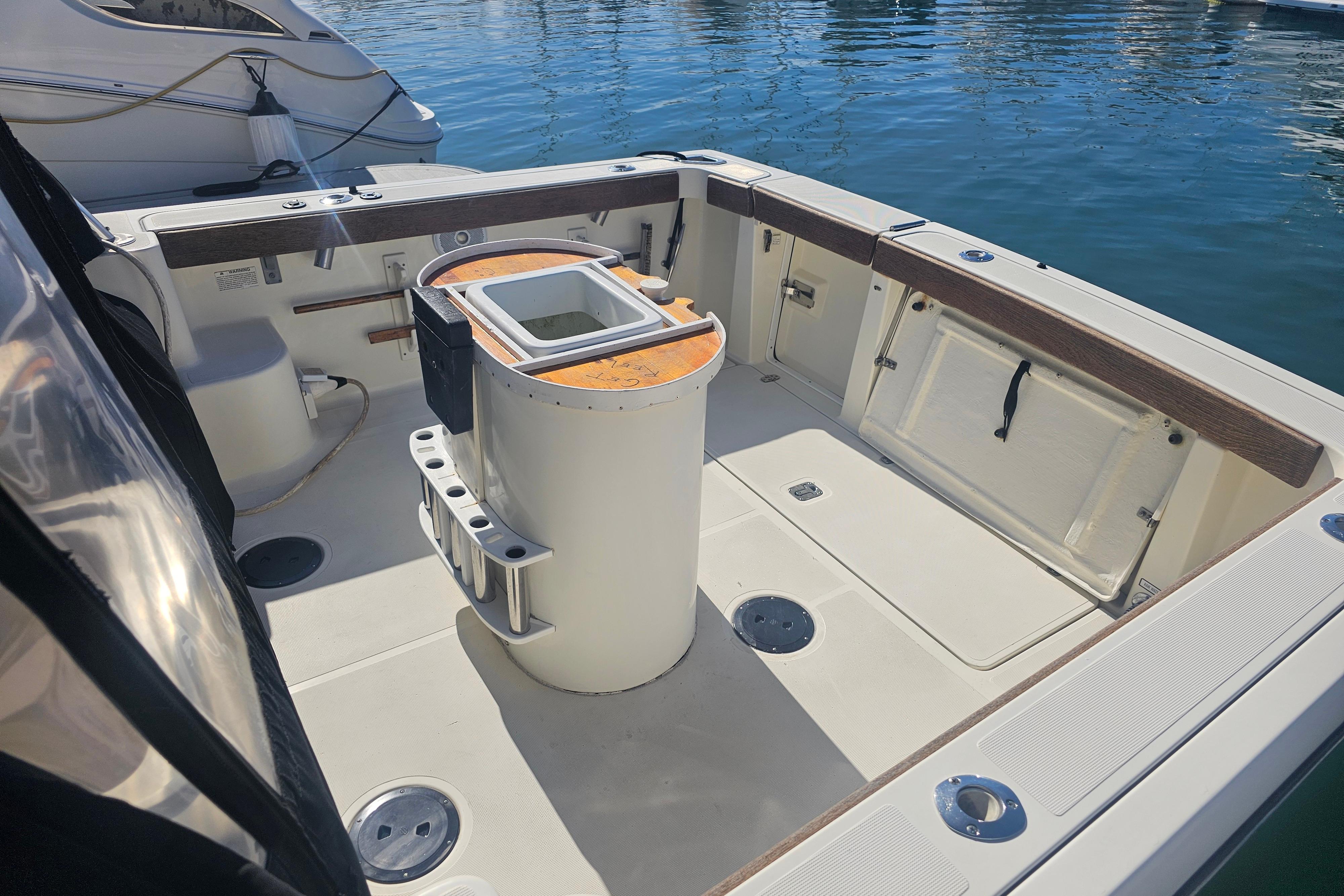 2001 Pursuit 3000 Express boat deck with fishing rod holders and storage compartments.