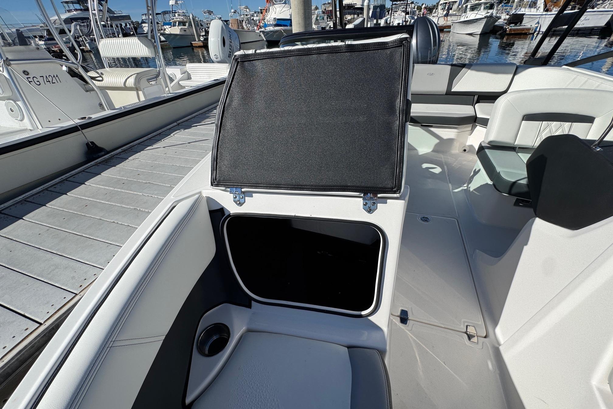 2026 Regal 21 OBX boat interior with open storage compartment at marina.