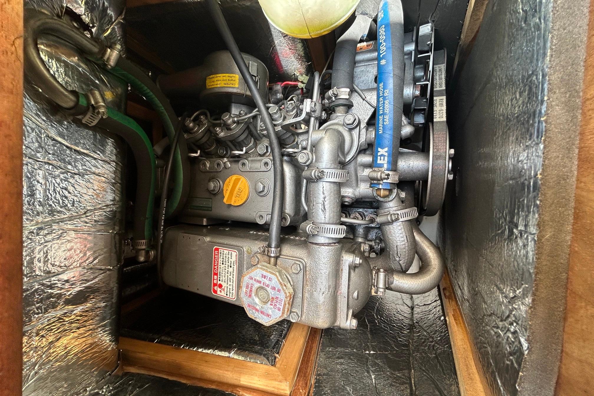 Engine compartment of a 1998 Hunter 340 sailboat, showcasing detailed mechanical components.