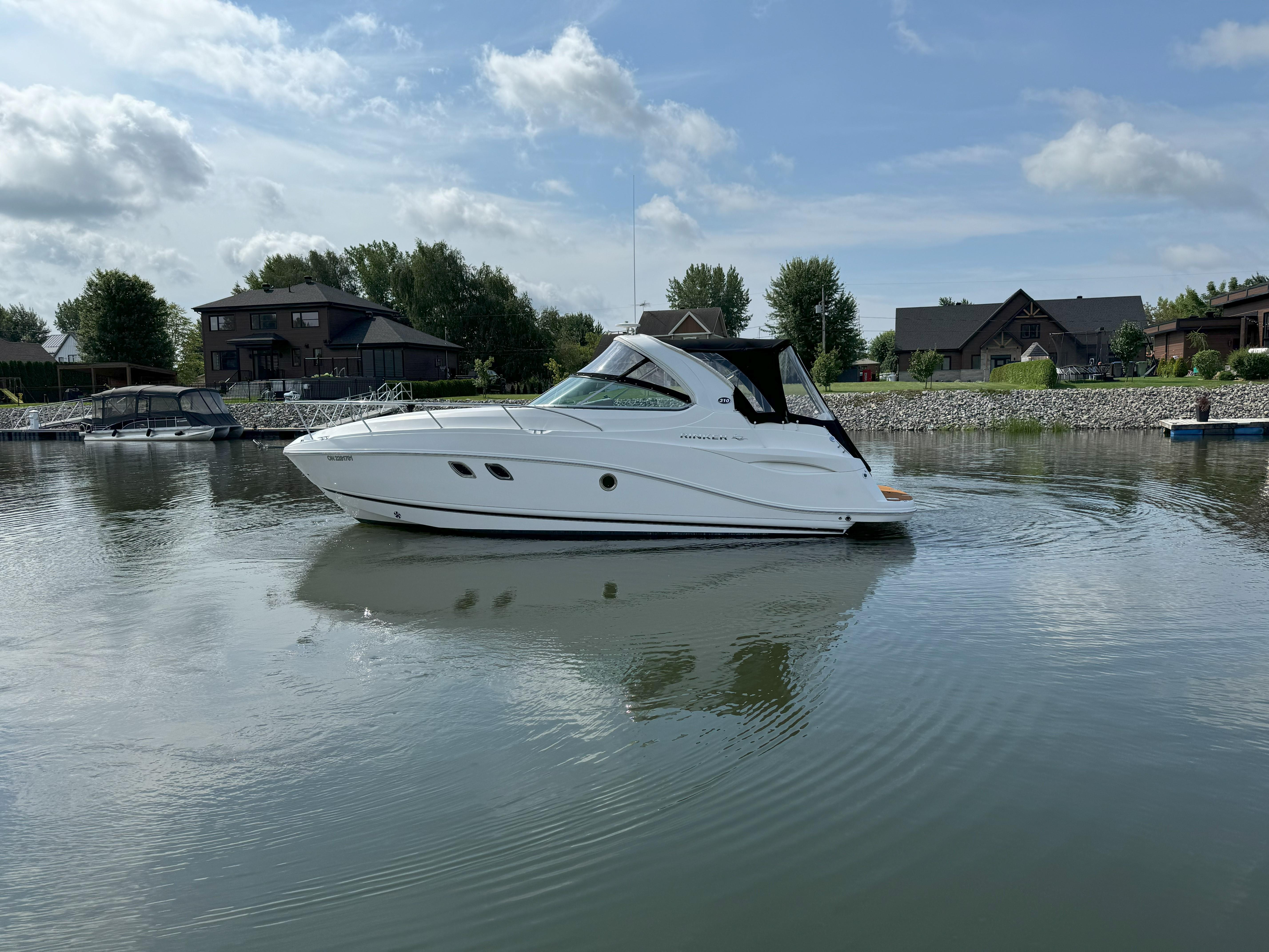 2010 Rinker 310 Express Cruiser on calm water.