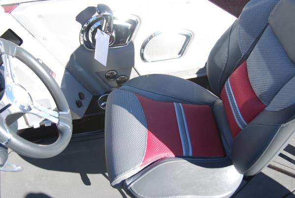 2024 Ranger 620FS Pro boat cockpit with steering wheel and red-gray seat.