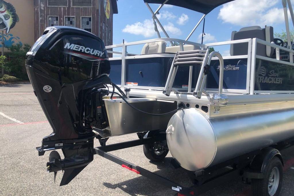 2026 Sun Tracker Bass Buggy 18 DLX pontoon boat with Mercury outboard motor.