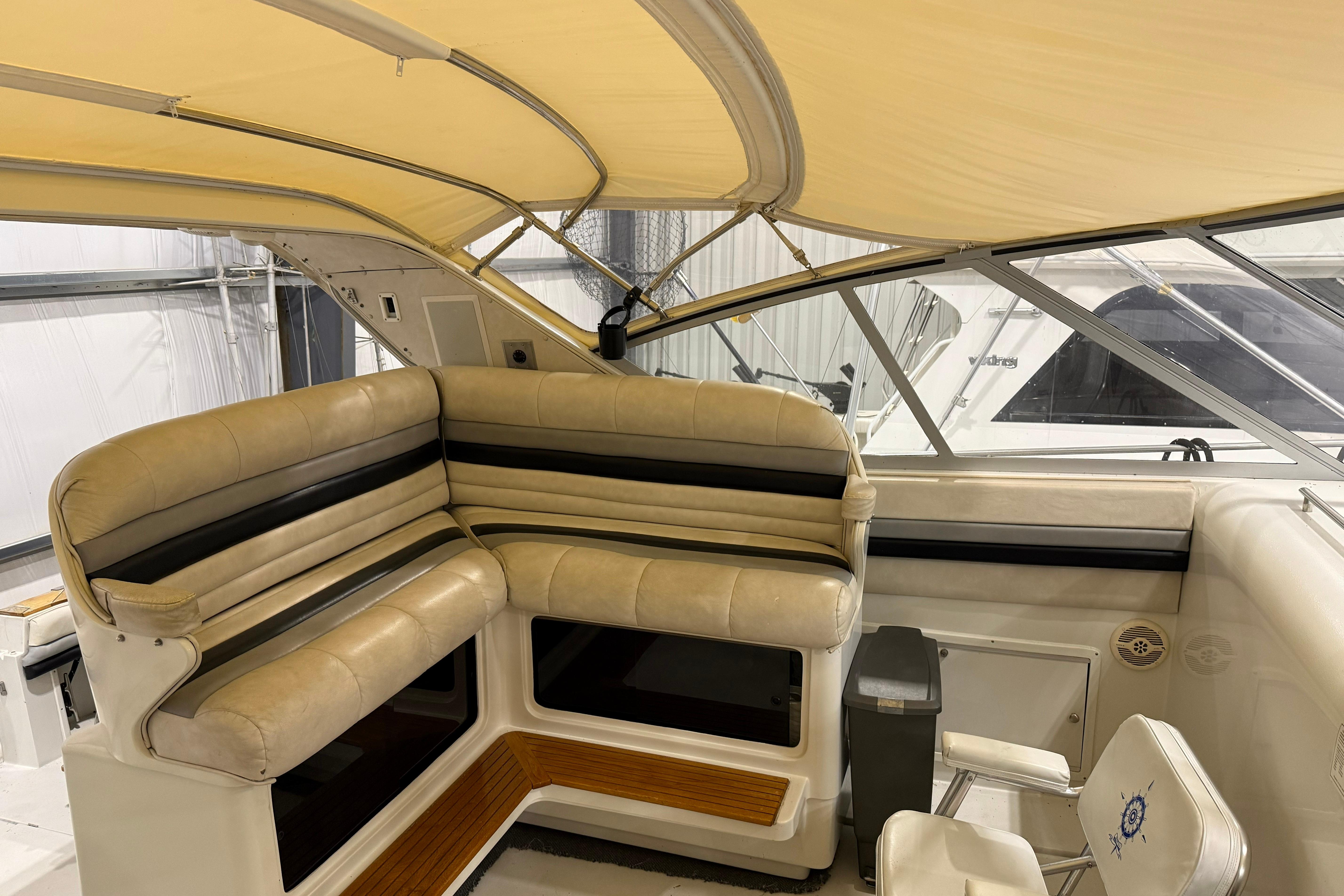 1988 Trojan 13 Meter Express 430 yacht interior with beige seating and canopy.