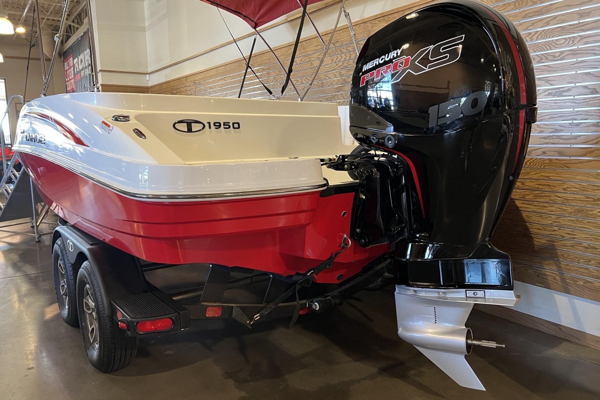 2025 Tahoe 1950 boat with Mercury Pro XS engine on display indoors.