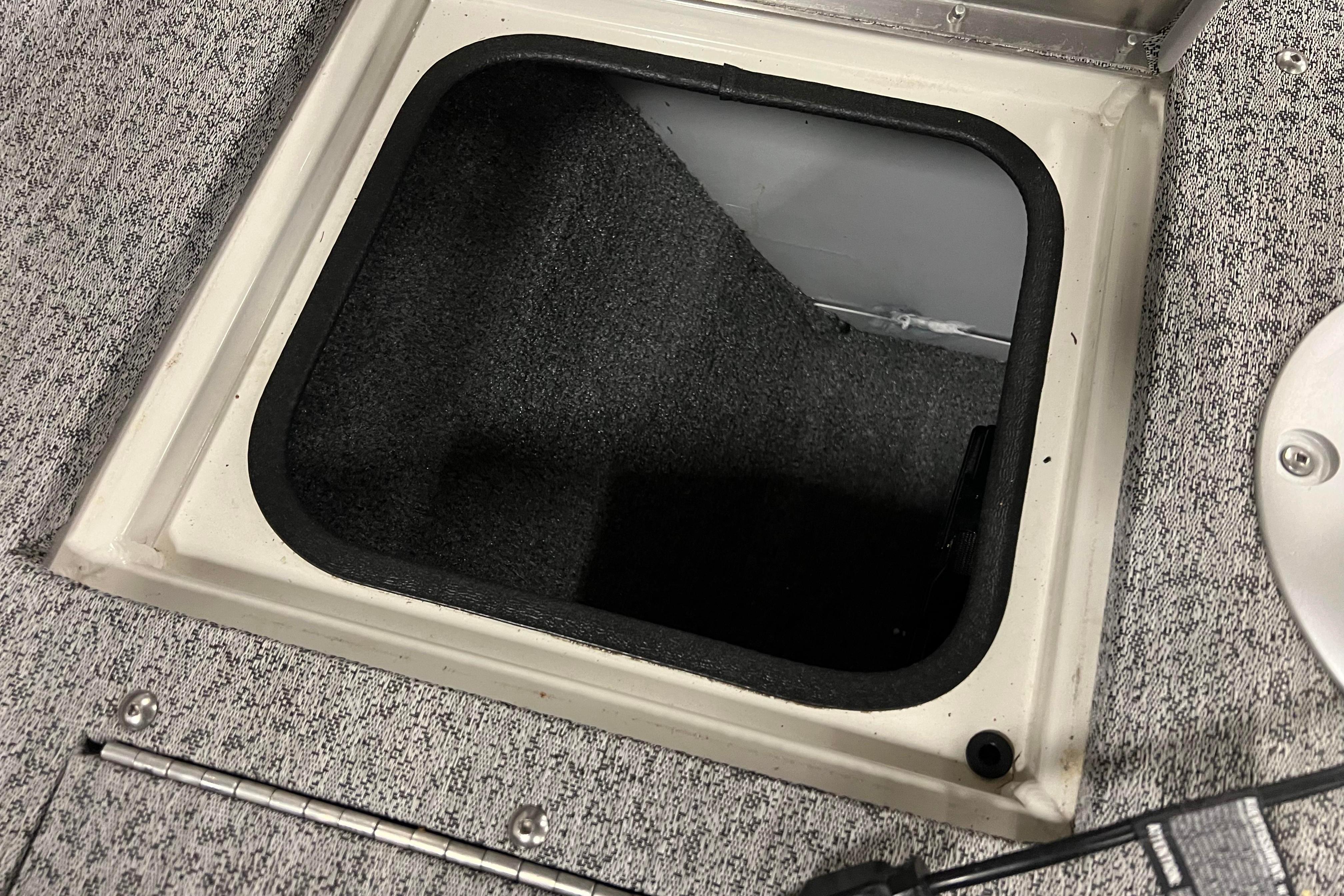 Open storage compartment in 2022 Tracker Pro Guide V-16 WT boat.