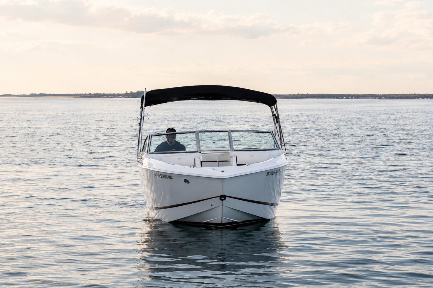 2019 Cobalt R3 boat on calm water under a cloudy sky.