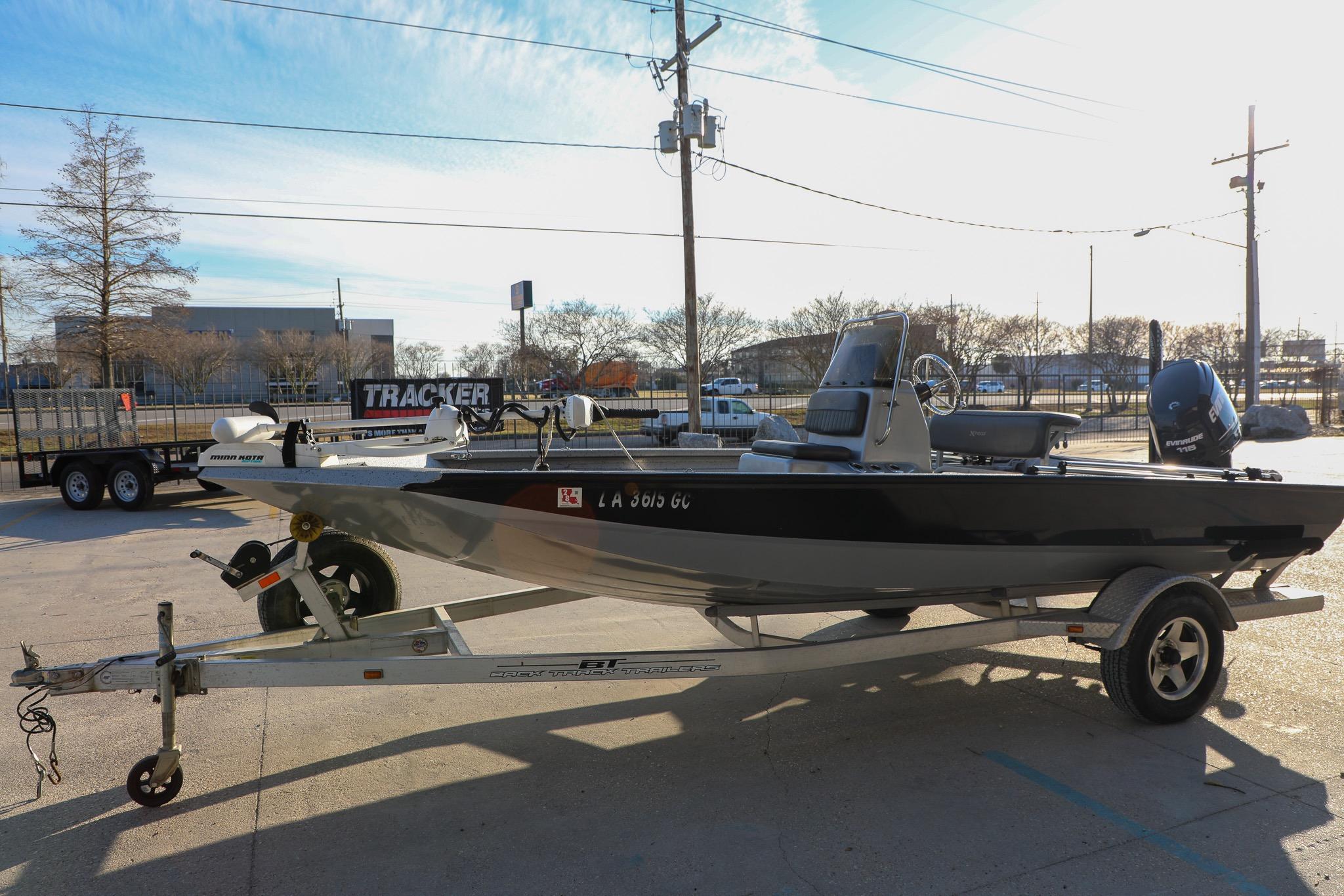 2019 Express 18 boat on trailer in parking lot, sunny day.