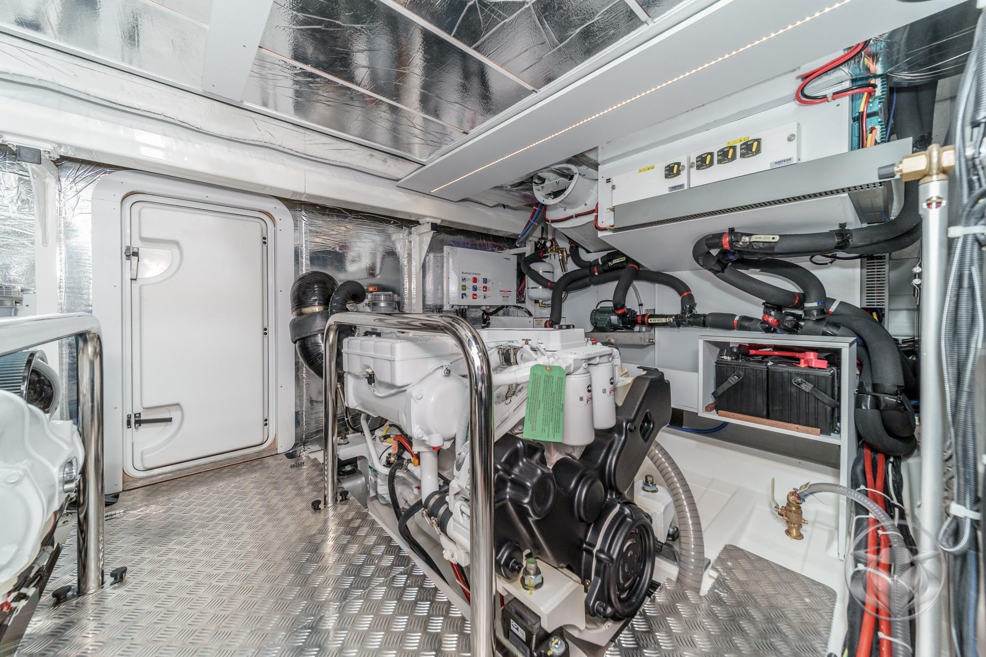Engine room of 2026 Beneteau Swift Trawler 54, featuring modern equipment and metallic finishes.