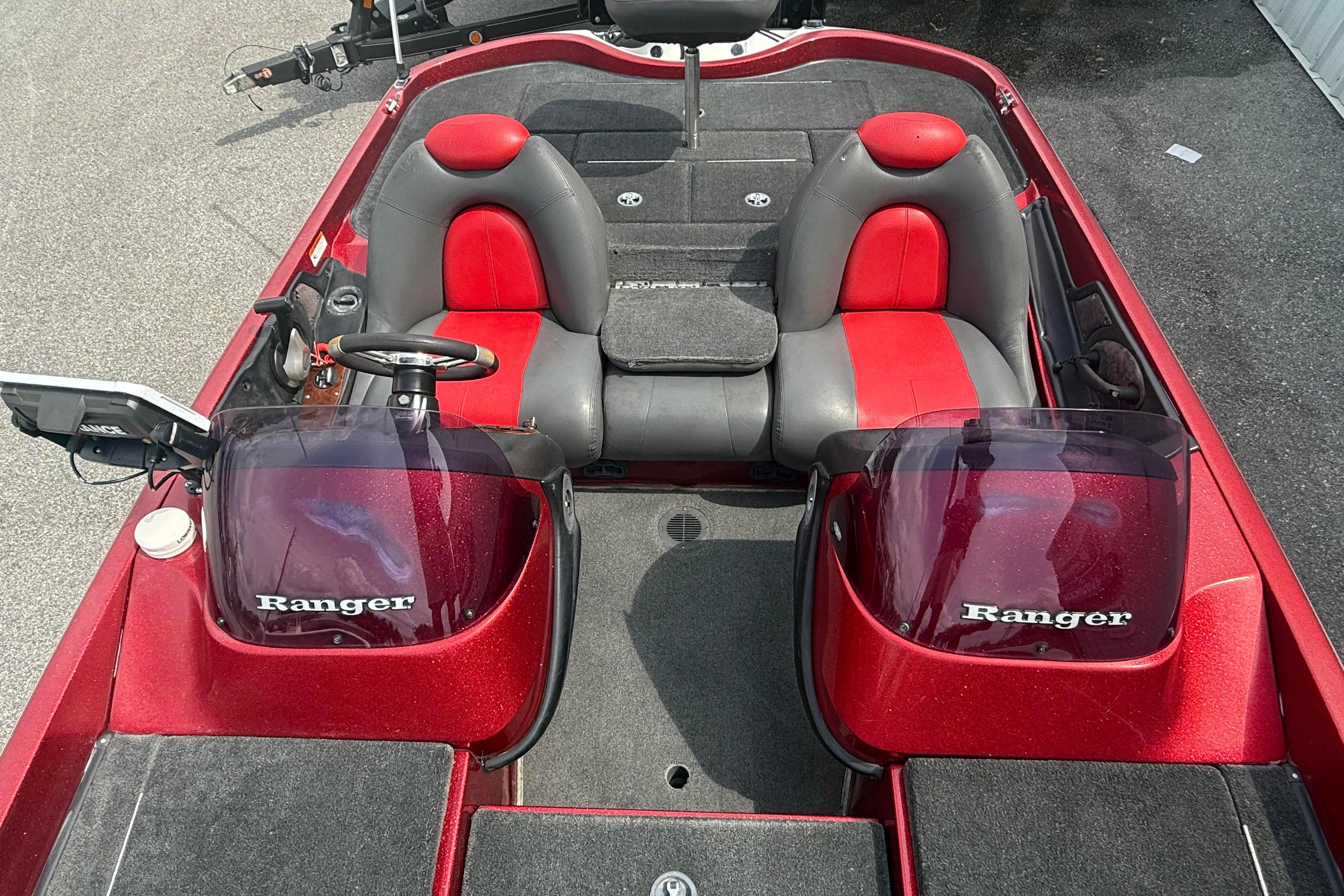 2007 Ranger 519 VX boat interior with red and gray seating, dual consoles, and steering wheel.