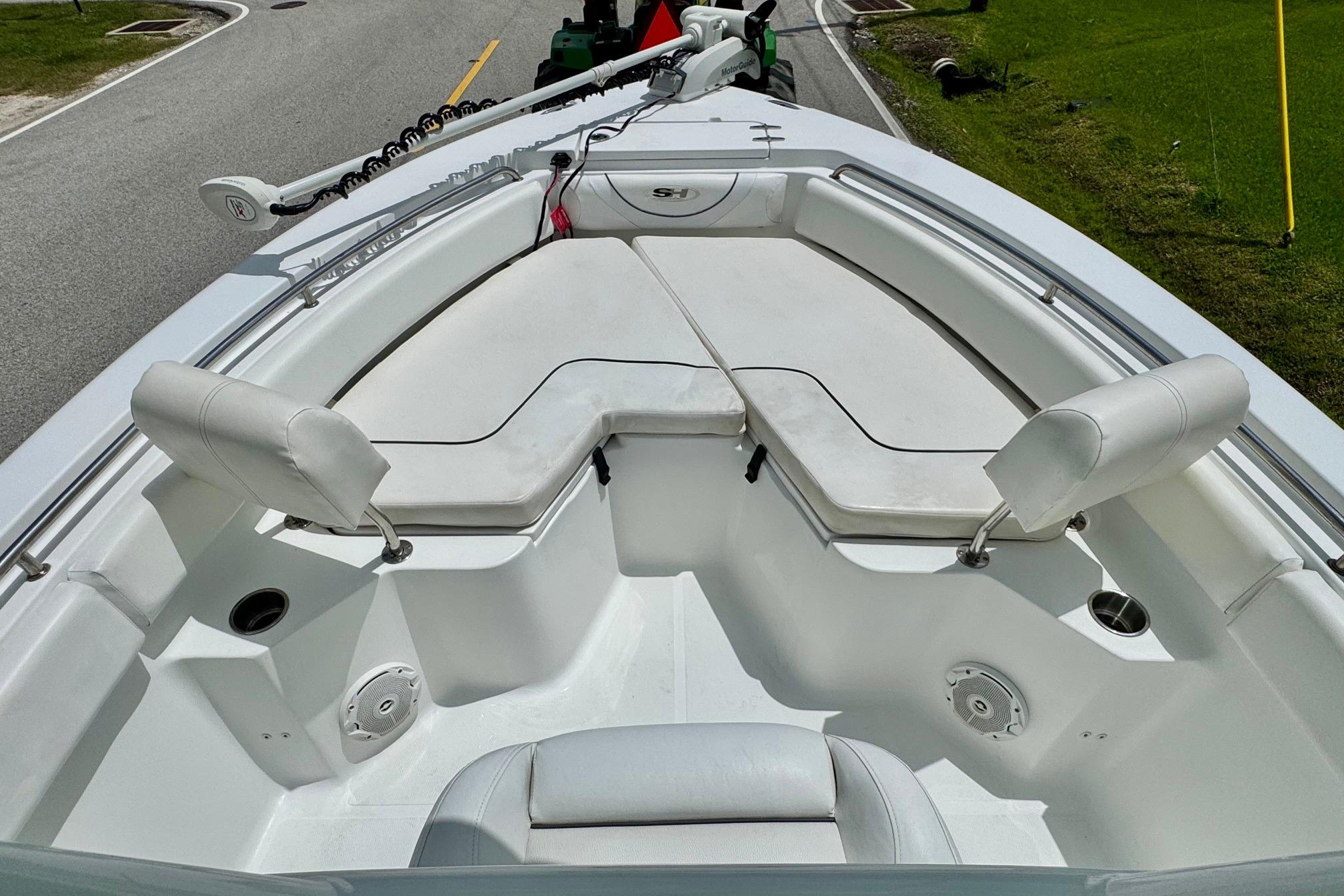 2015 Sea Hunt Ultra 234 boat interior with cushioned seating and cup holders.