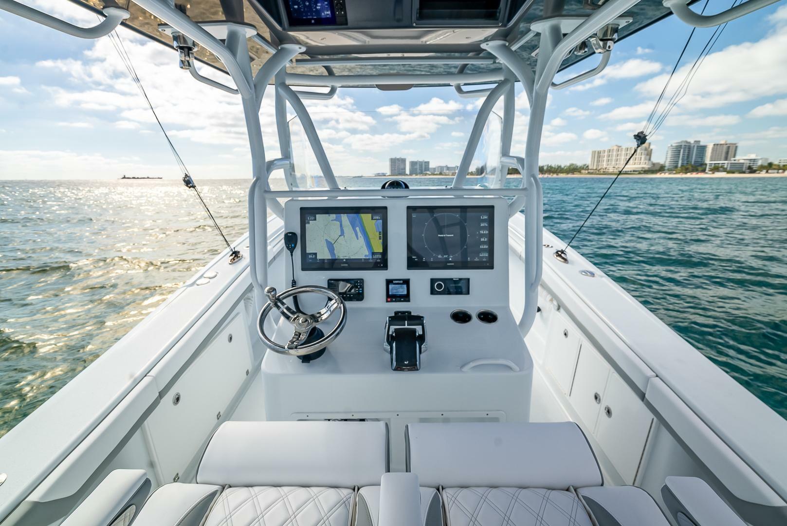 2023 Yellowfin 36 Offshore boat dashboard with ocean view and modern navigation equipment.