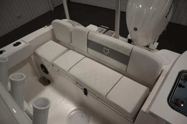 2025 Sea Fox 228 Commander boat interior with white cushioned seating and rod holders.