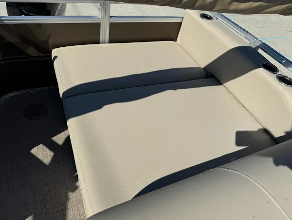 2025 Sun Tracker 24 Sportfish XP3 boat interior with beige seating and cup holders.