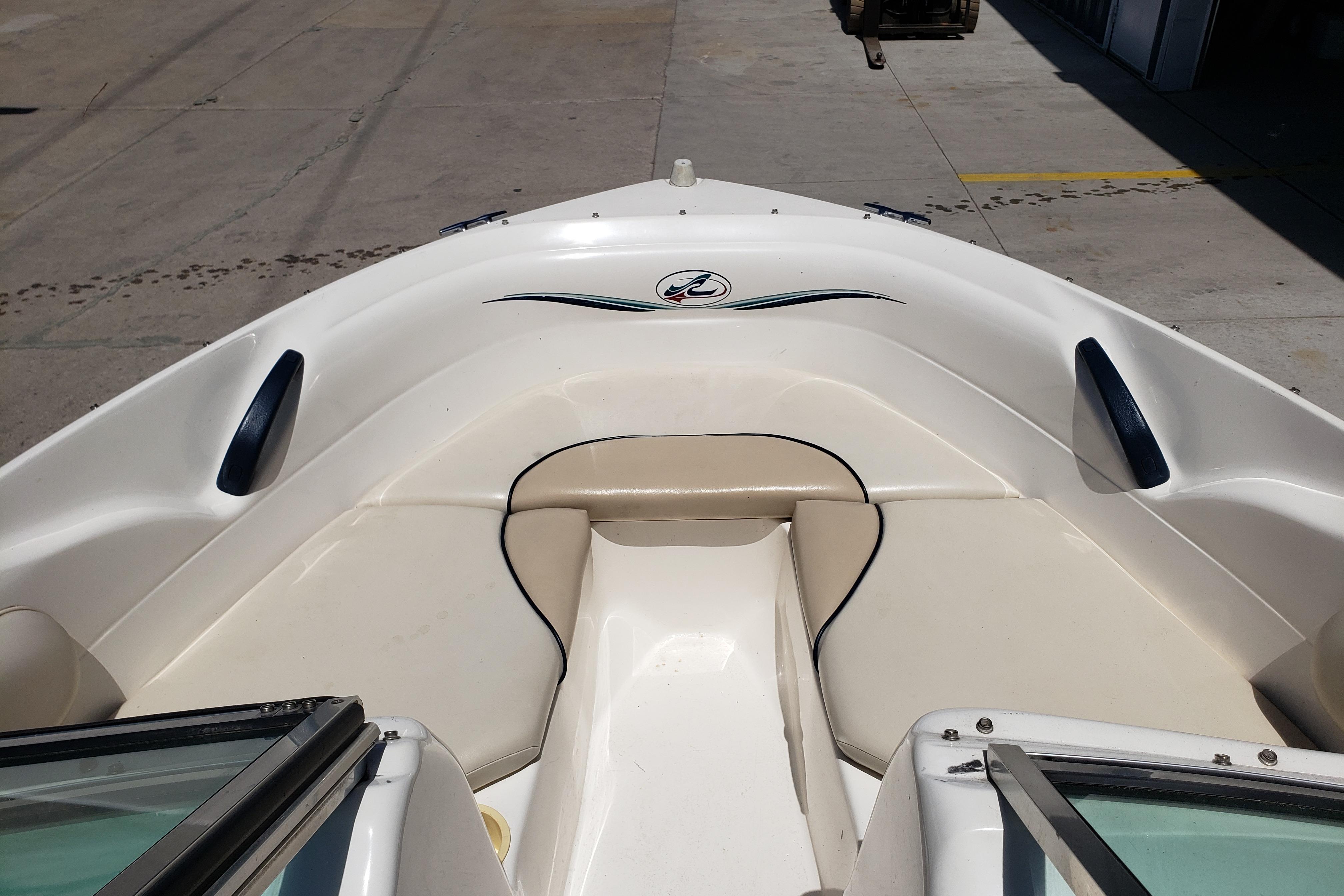 1998 Sea Ray 180 Bow Rider boat interior with beige seating and sleek design.