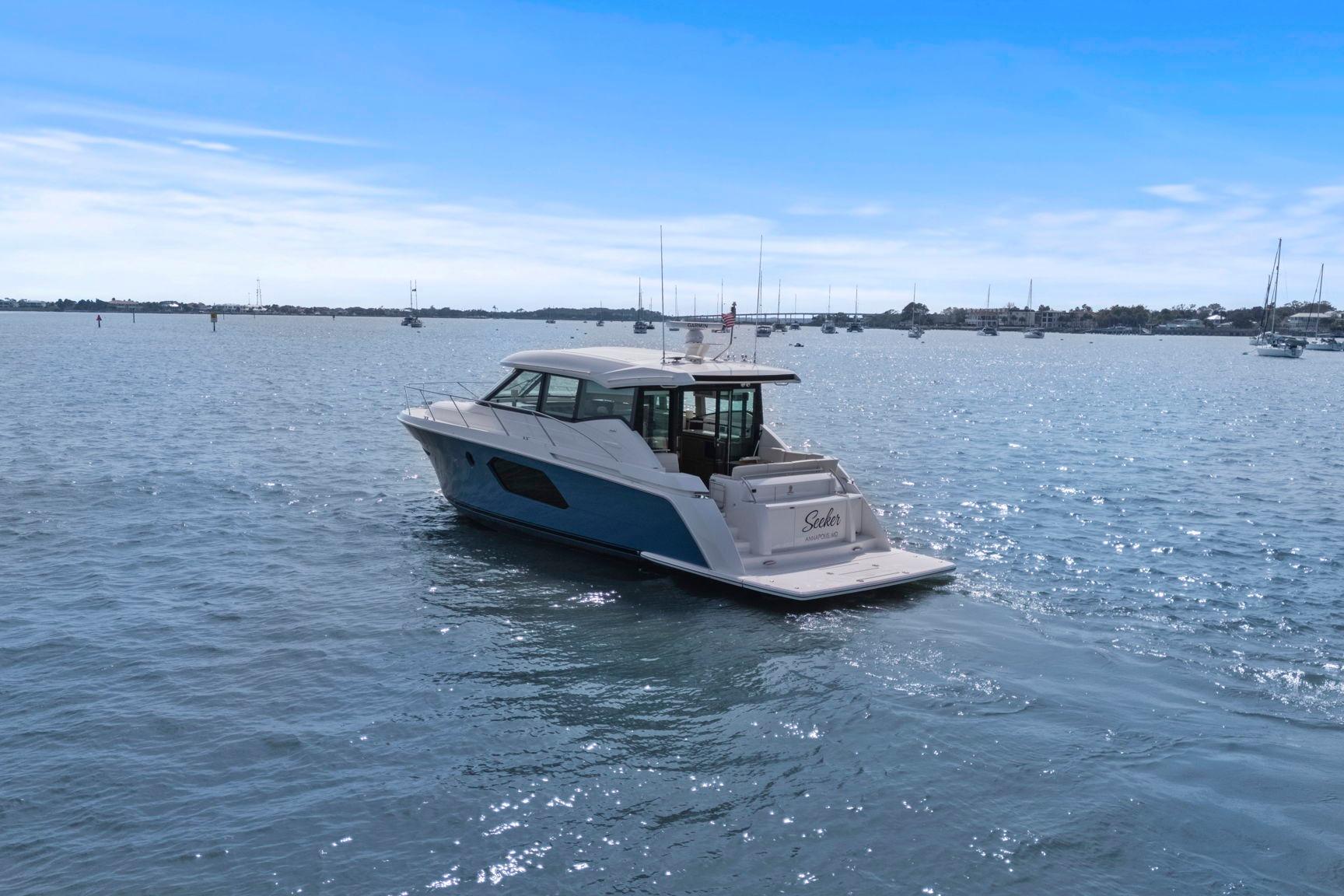 2023 Tiara Yachts C49 Coupe cruising on a sunny day in open waters.