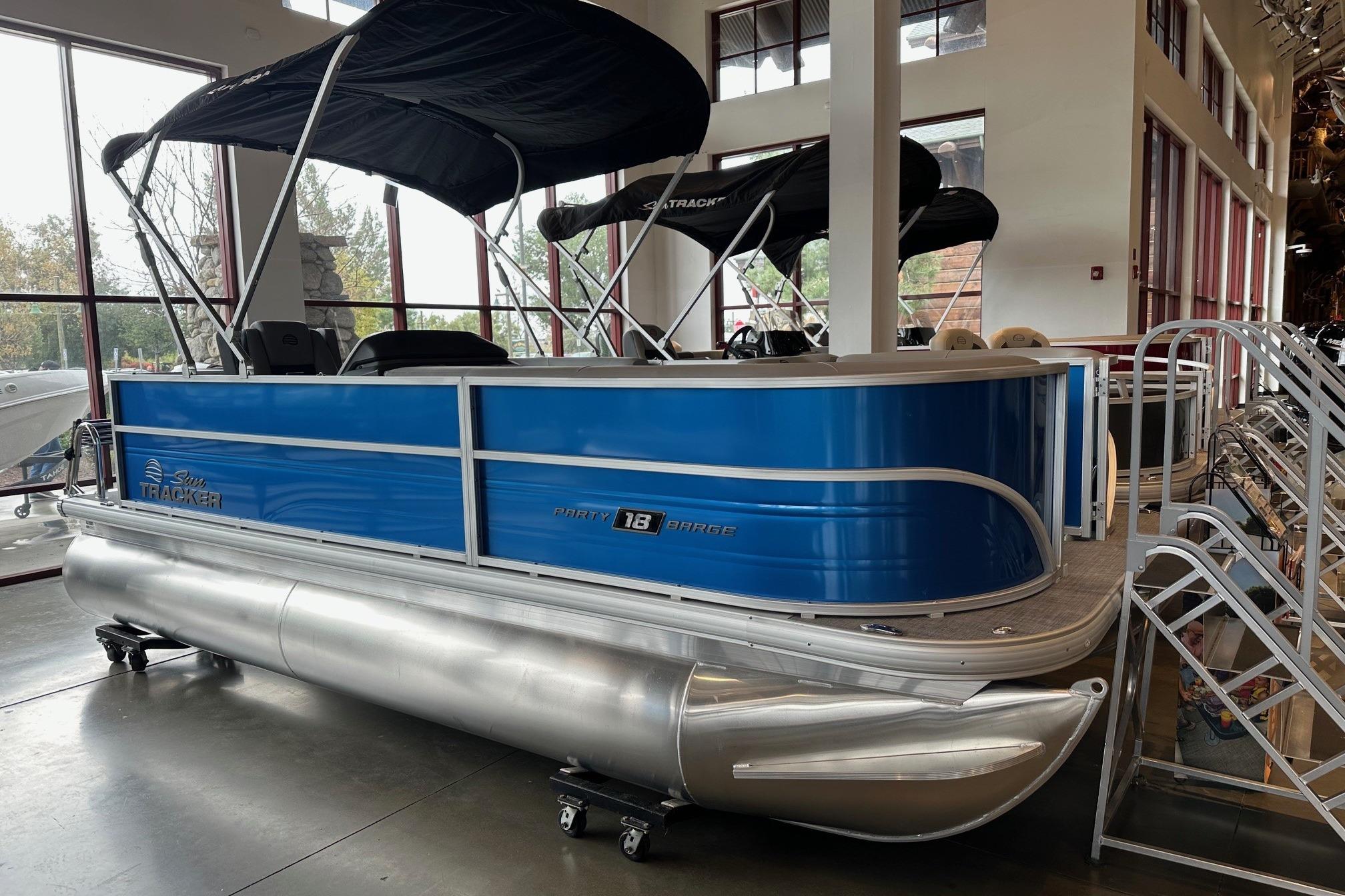 2026 Sun Tracker Party Barge 18 DLX pontoon boat displayed indoors.