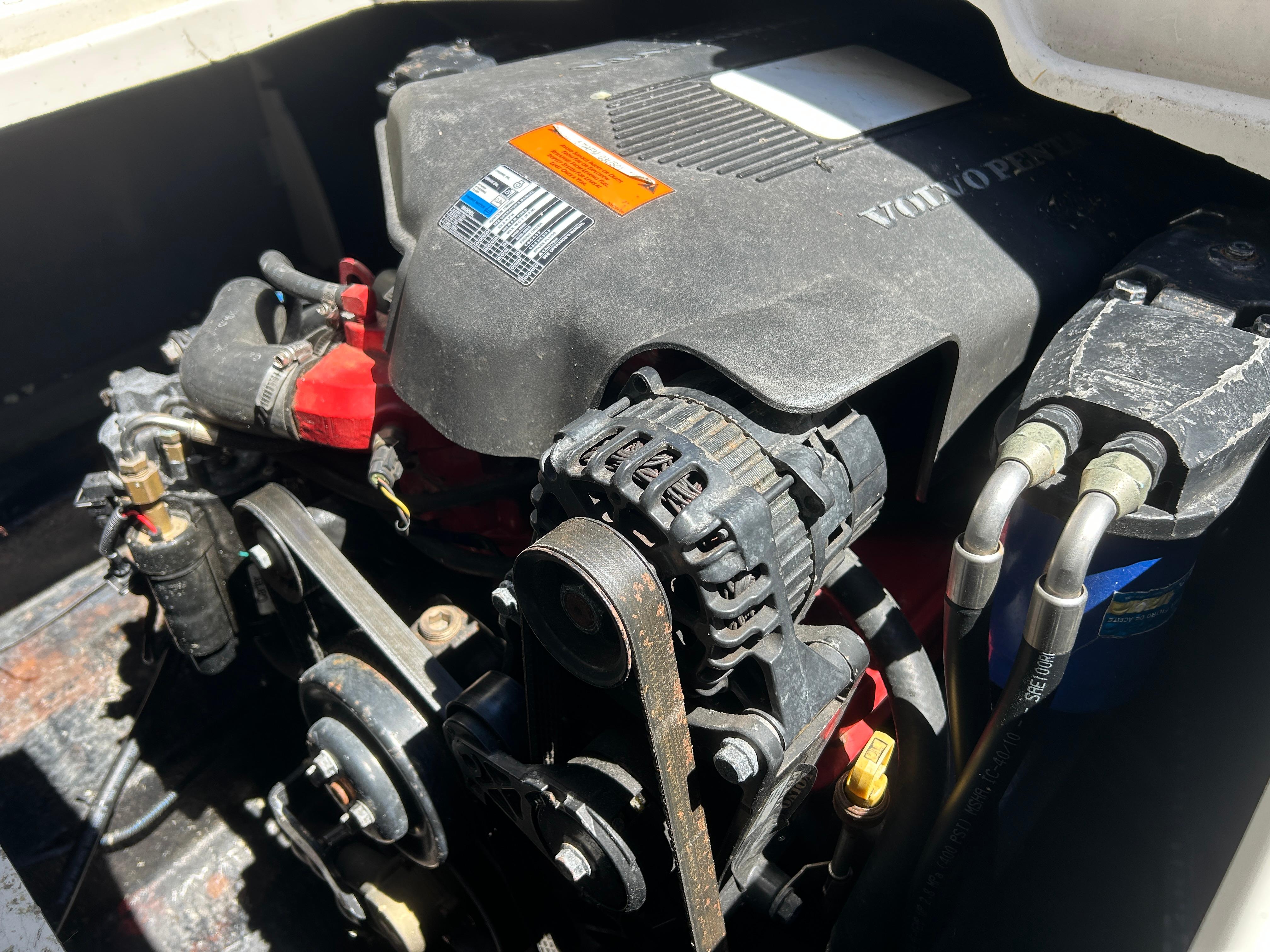 Engine compartment of a 2003 Stingray 240 LR boat, featuring a Volvo Penta engine.