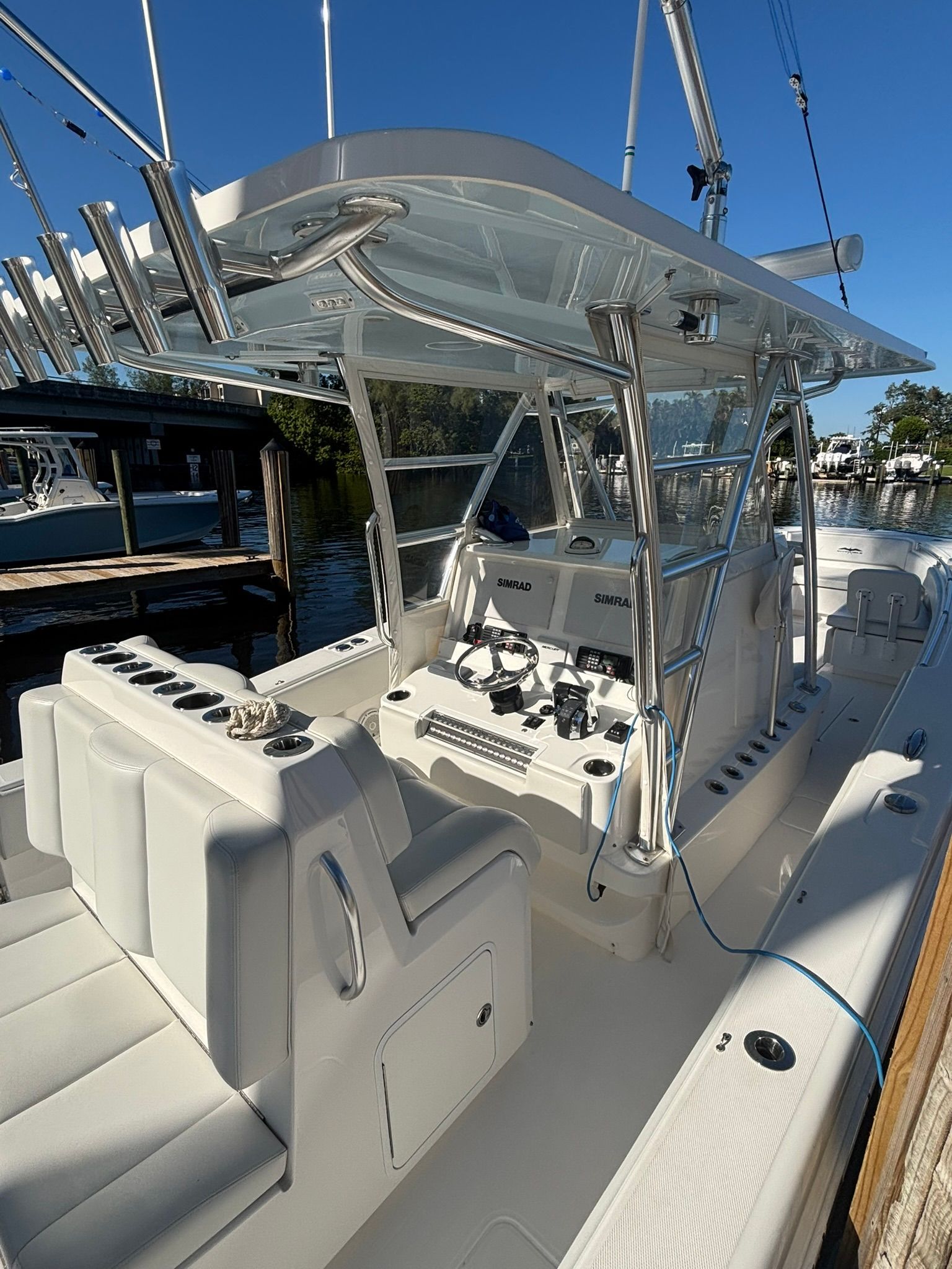 Invincible 36 boat 2018, modern cockpit design, docked at marina.