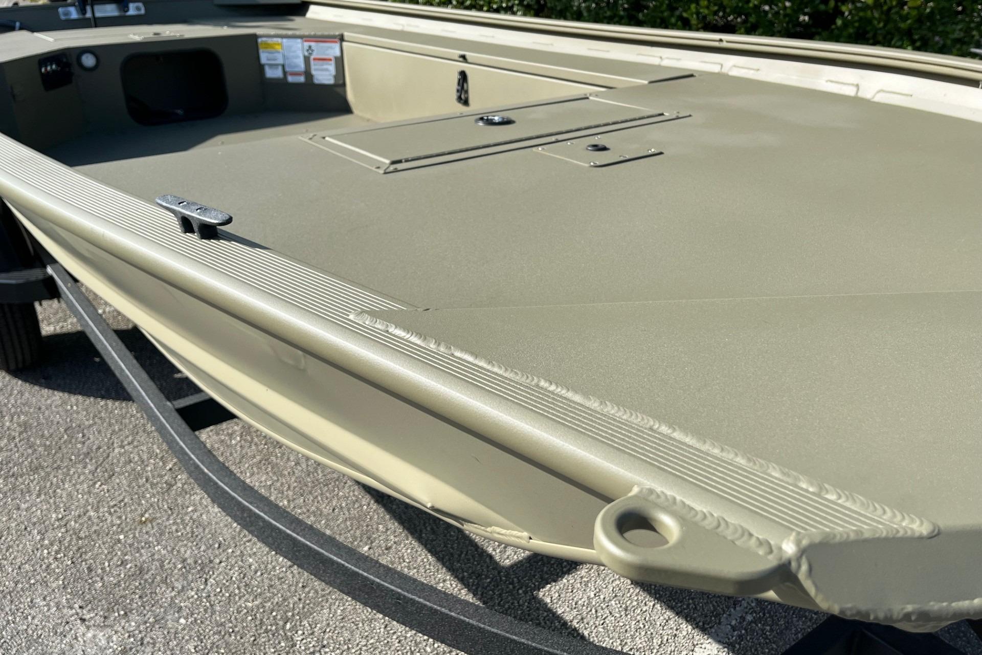 2026 Tracker Grizzly 1654 T Sportsman boat, showcasing deck and storage compartments.