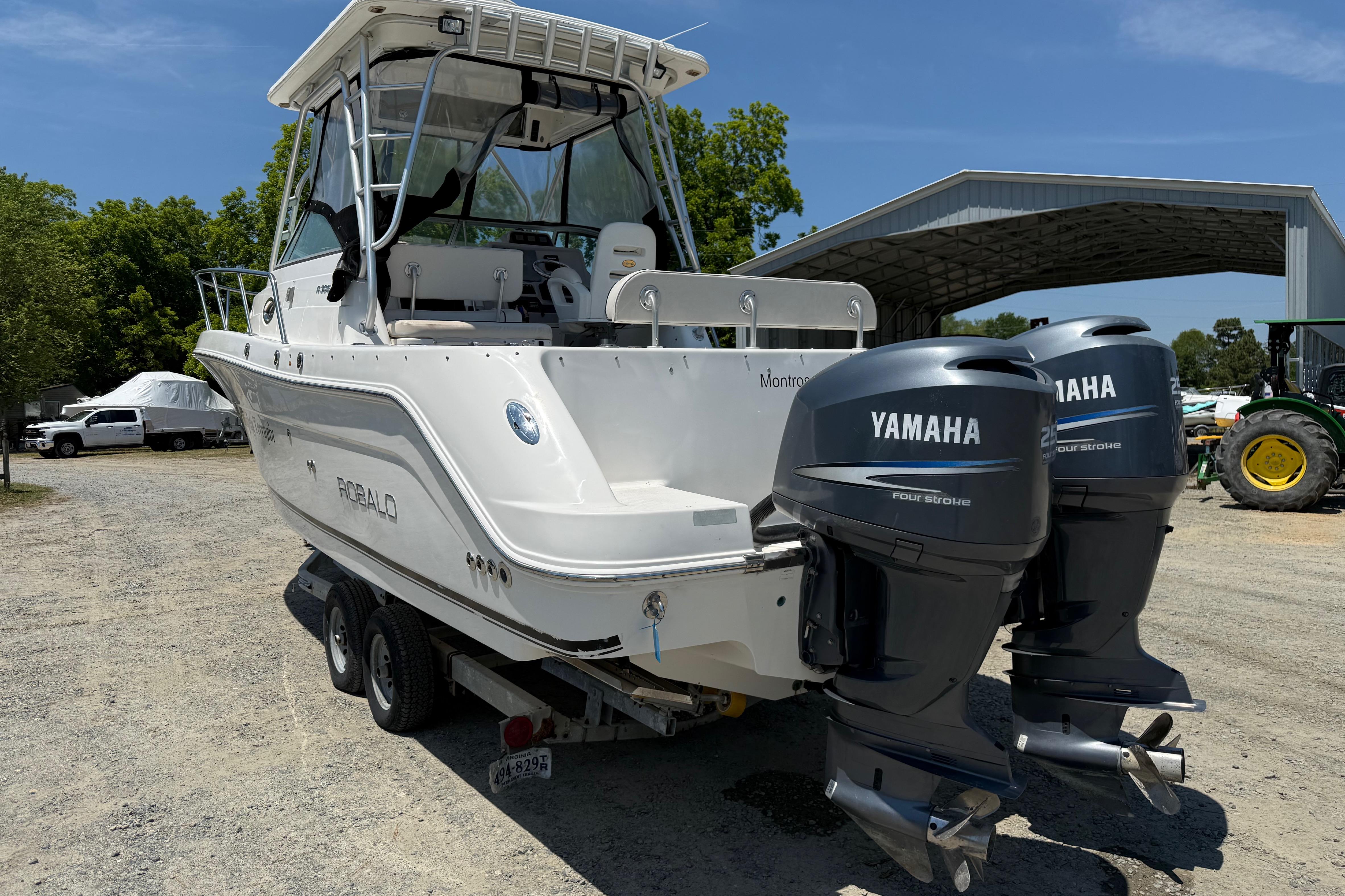 2007 Robalo R305 Walkaround boat with twin Yamaha engines on a trailer.