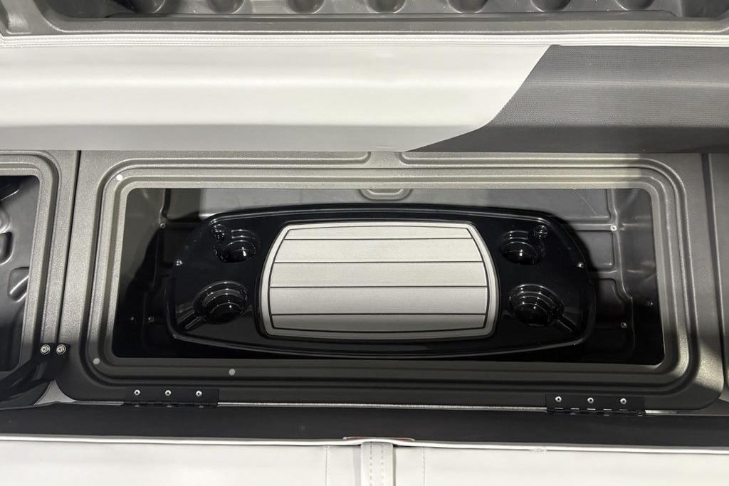 2026 Sun Tracker PARTY BARGE® 20 DLX storage compartment with cup holders and tray.