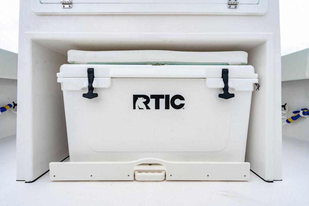 RTIC cooler on 2027 Reef Runner 280 boat, securely placed in storage compartment.