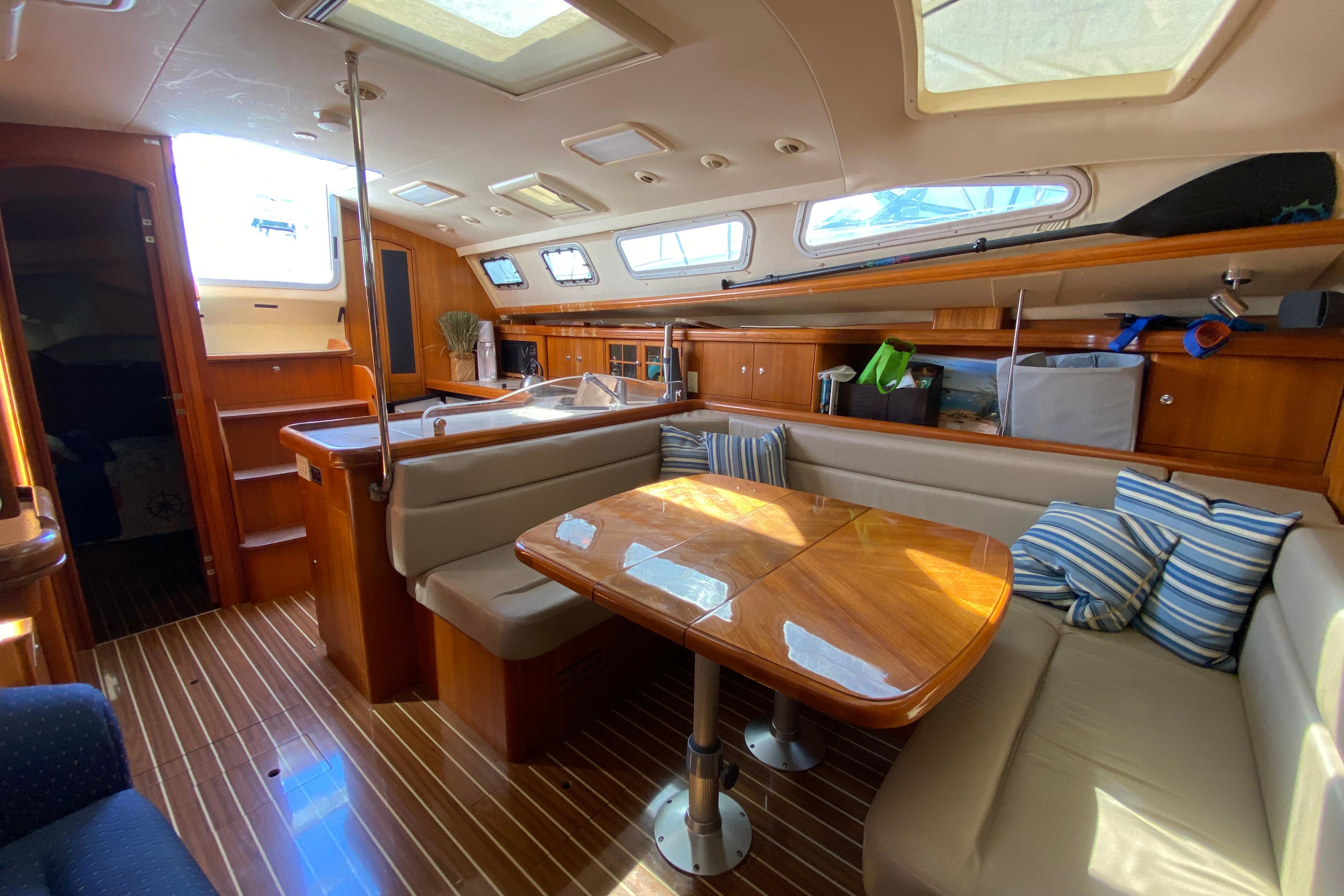 Luxurious interior of 2004 Hunter 41 AC yacht with wooden finishes and seating area.