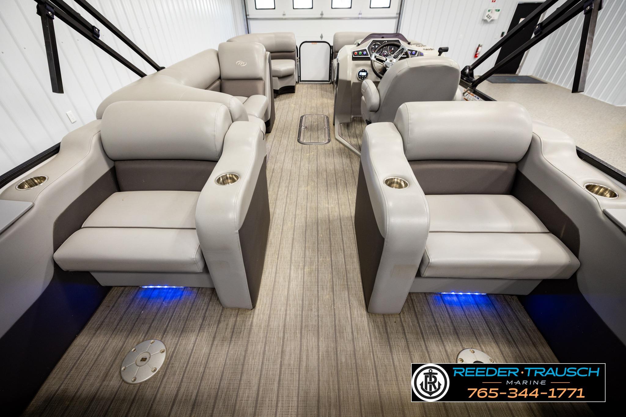 Luxurious interior of 2019 Manitou Oasis SR VP pontoon boat with plush seating and cup holders.
