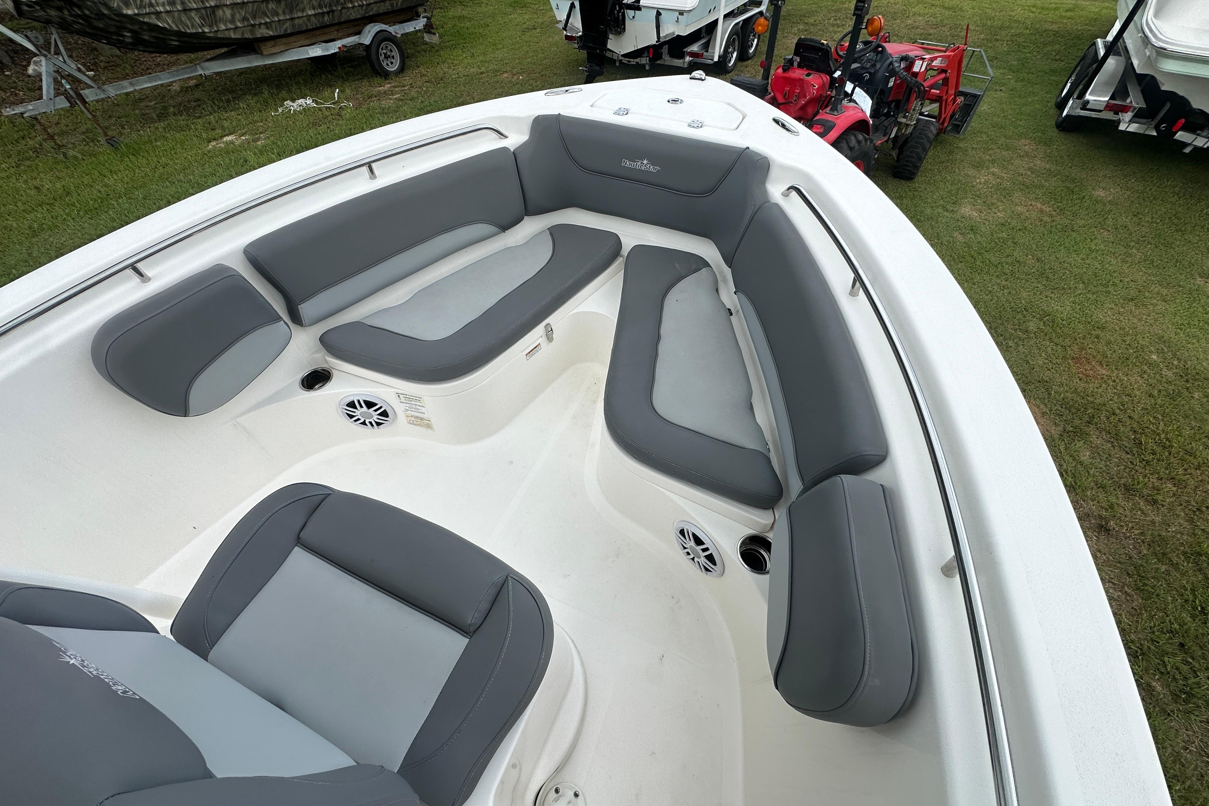 2023 NauticStar 2102 Legacy boat interior with gray seating and speakers.