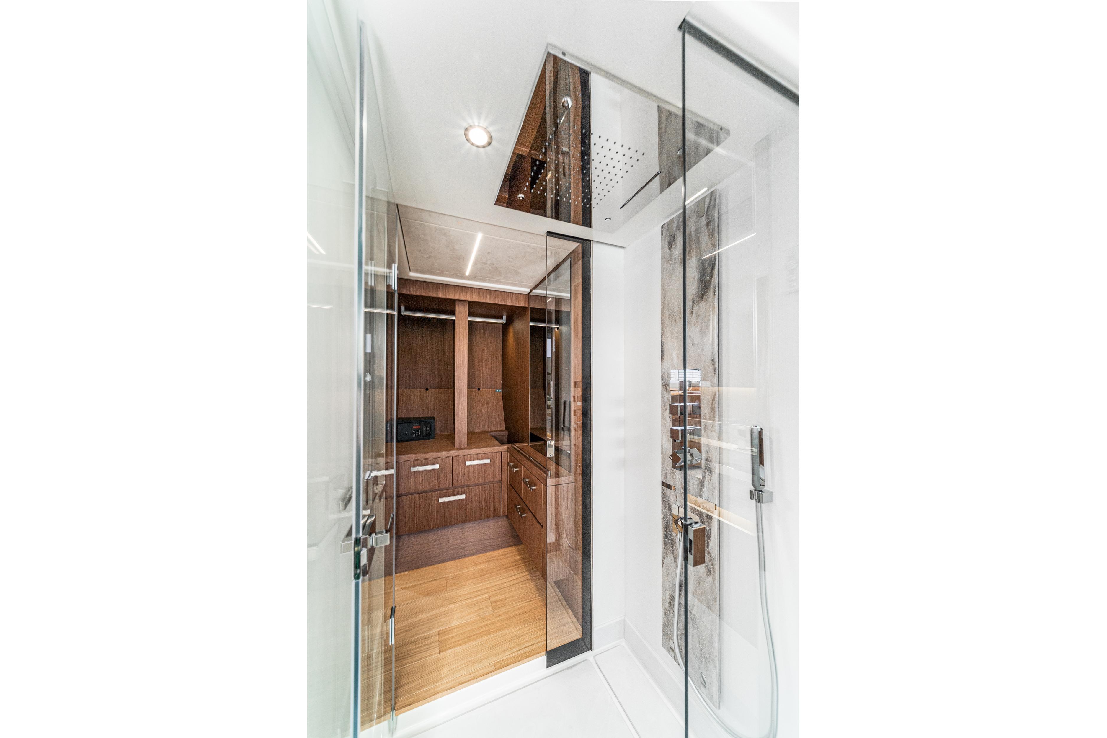 Luxurious interior of 2024 Prestige X60 yacht featuring modern shower and wooden cabinetry.