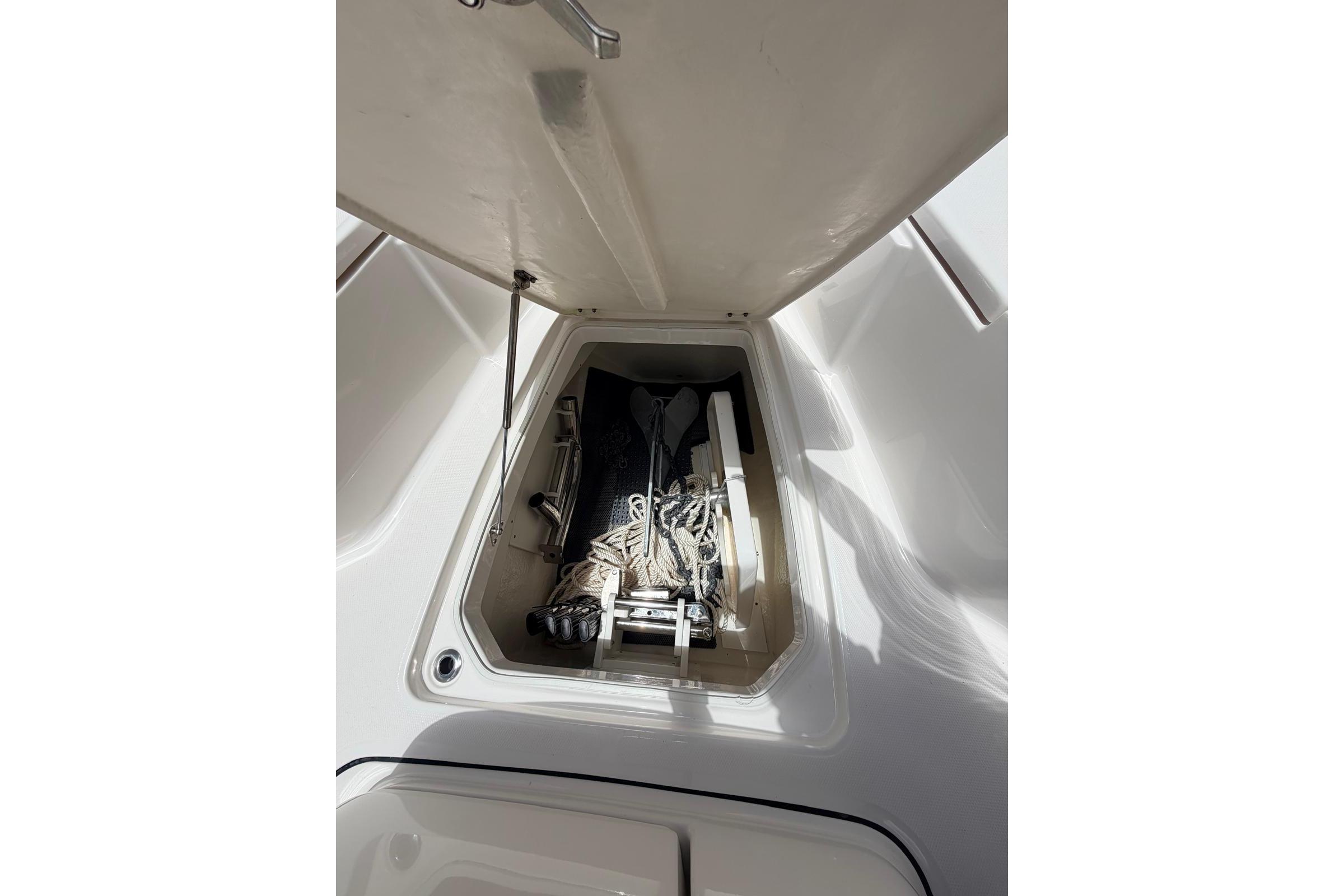 2022 Robalo R302 Center Console storage compartment with ropes and equipment.