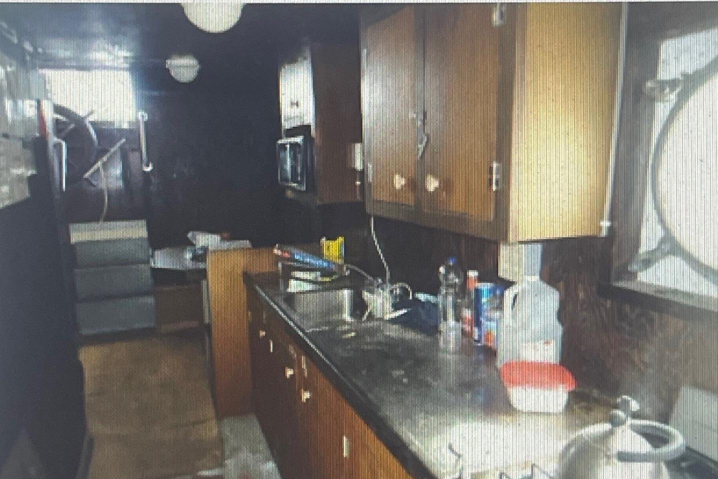 Interior of a 1984 commercial freezer shrimp trawler kitchen with wooden cabinets and countertop.