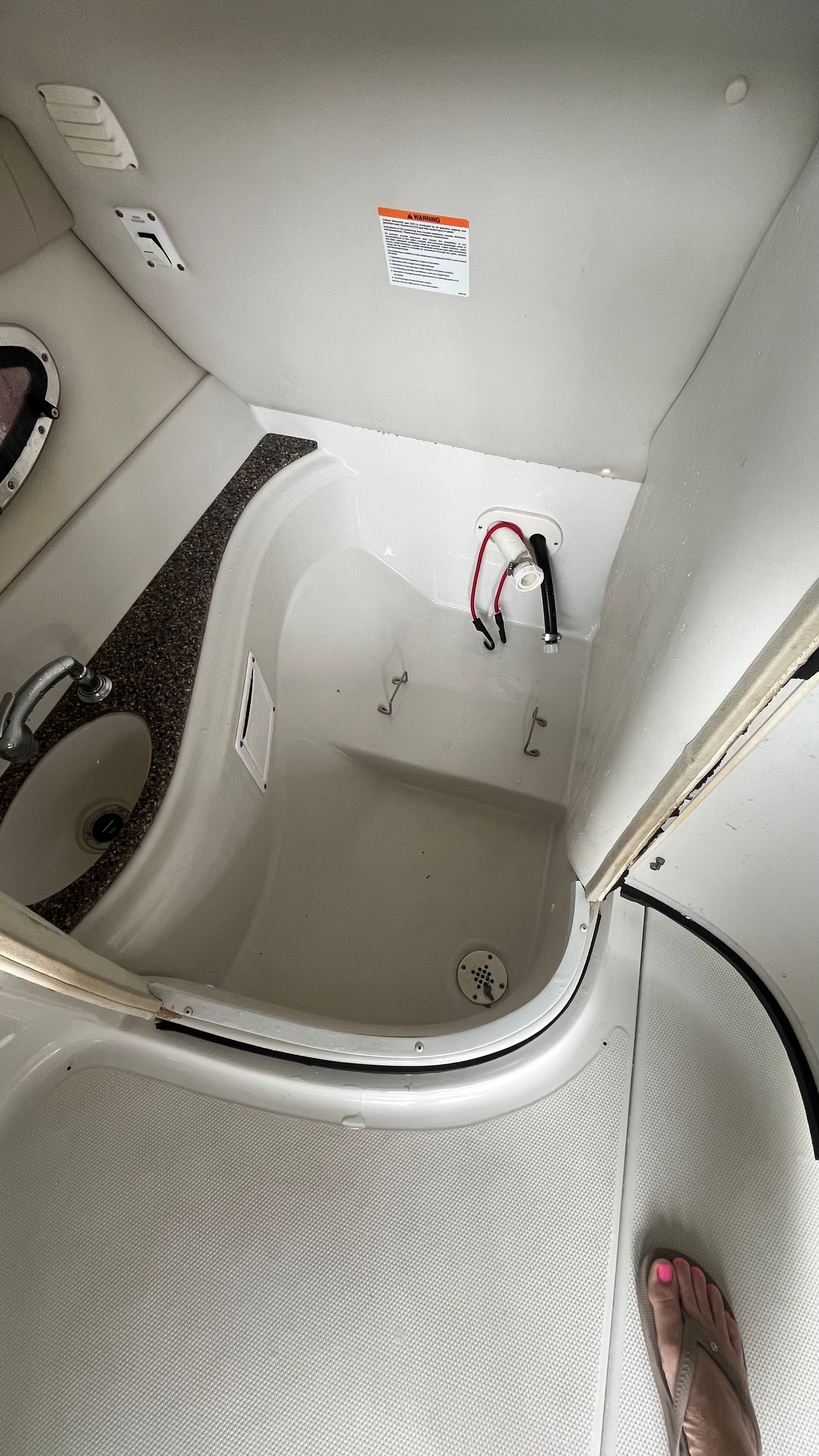 Interior view of a boat with a sink and storage area.