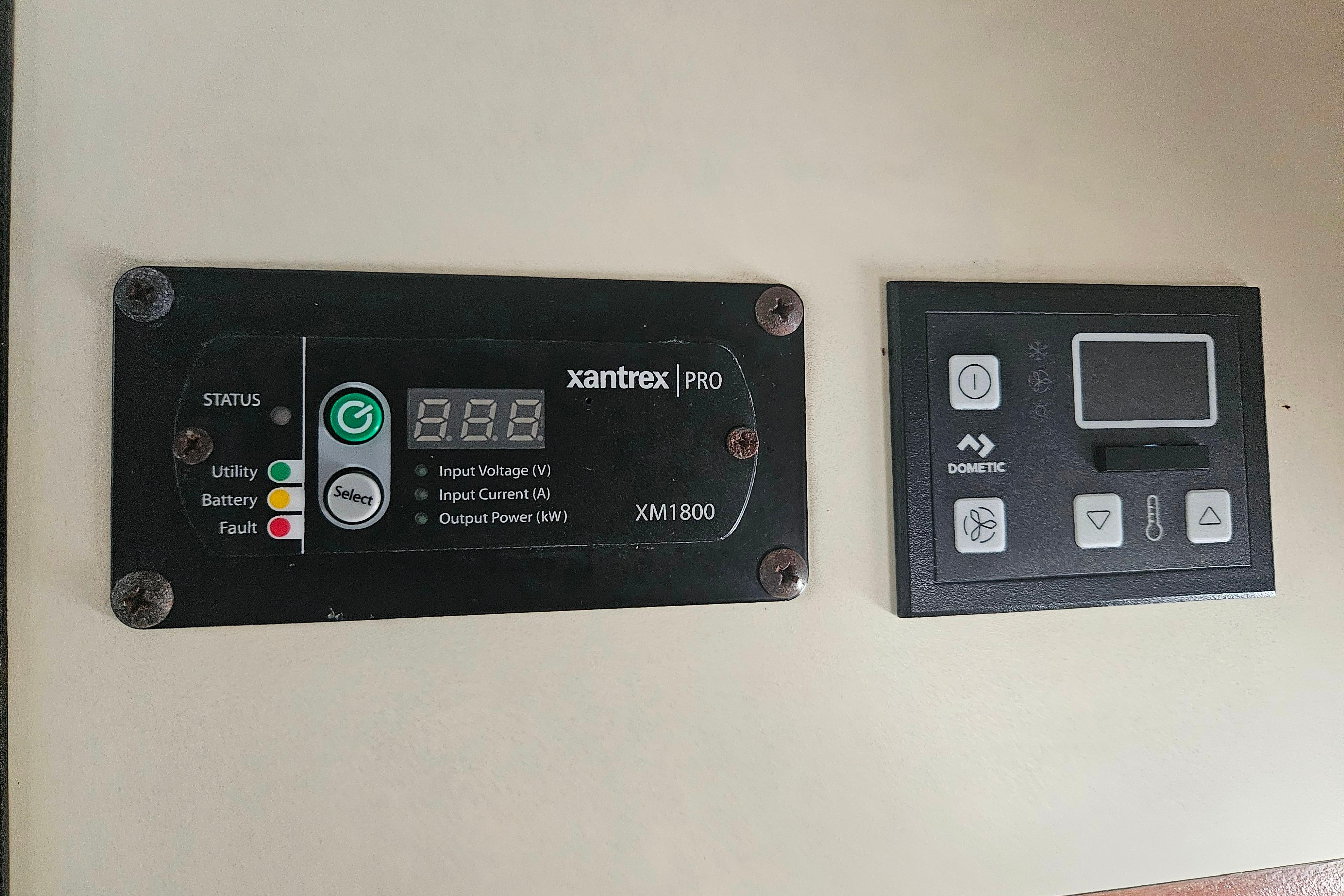 Control panels on a 1999 Albin 28 Tournament Express boat, featuring Xantrex and Dometic systems.