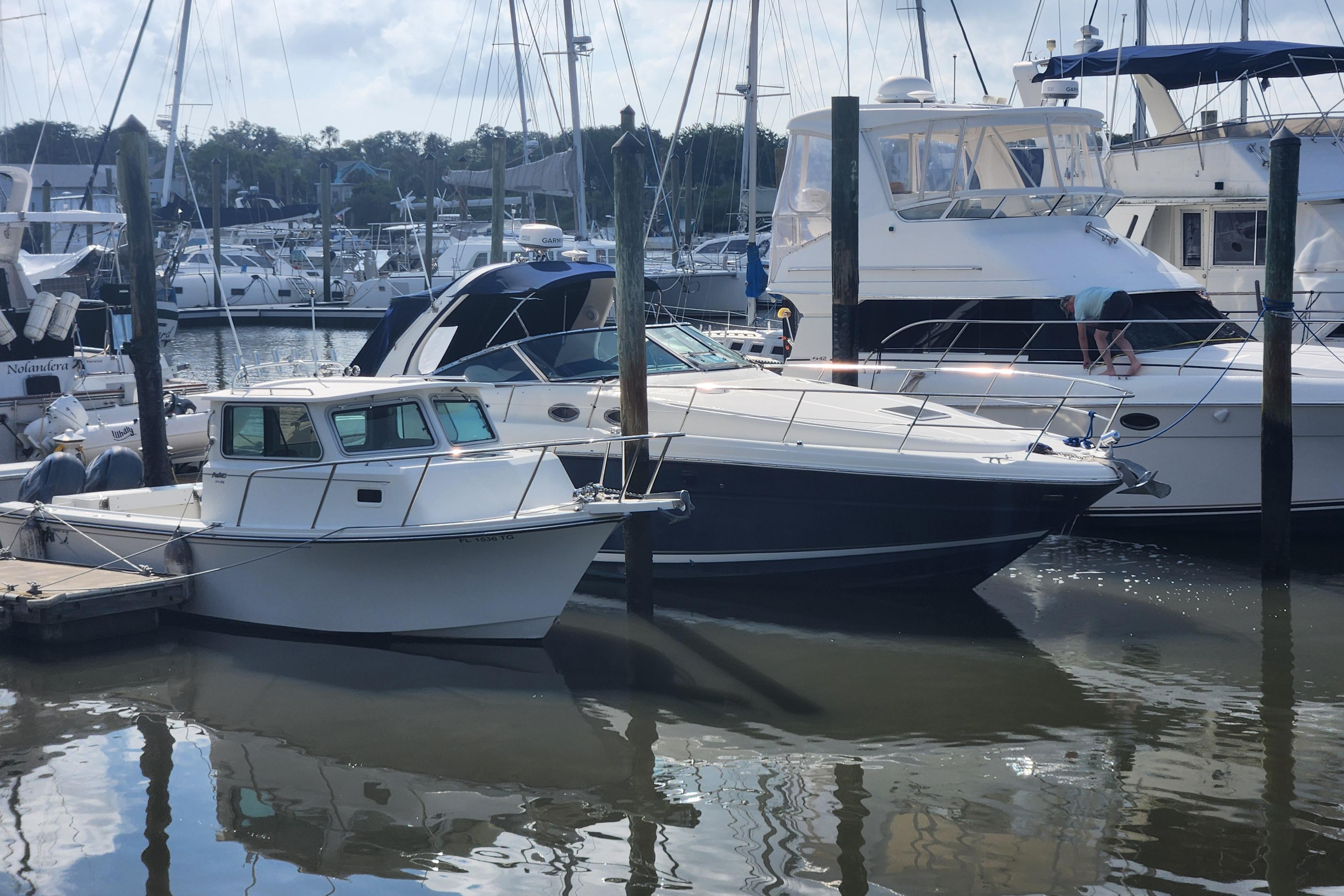 2003 Sea Ray 360 Sundancer docked at a marina with other boats.