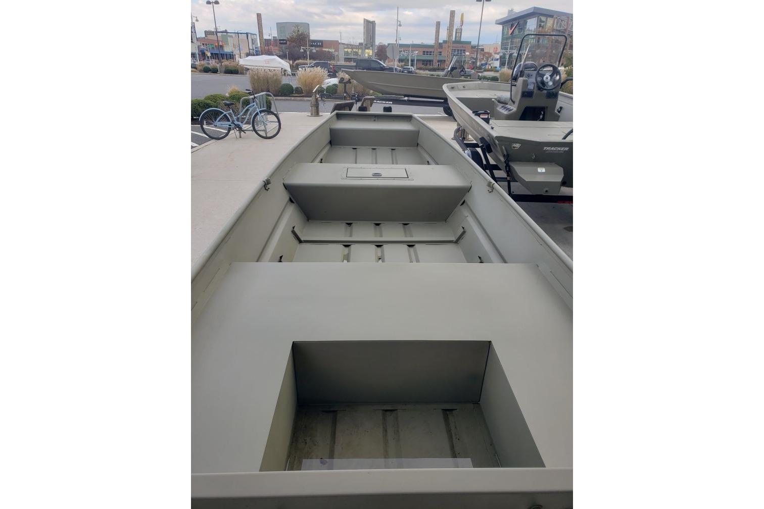 2026 Tracker Grizzly 15 Jon boat displayed outdoors, showcasing spacious interior and sturdy design.