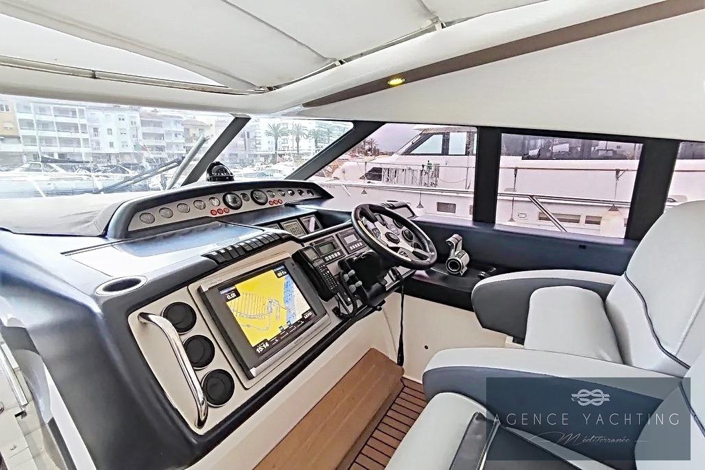 Cockpit of 2004 Princess V58 yacht with navigation system and steering wheel.
