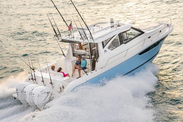 Manufacturer Provided Image: 2025 Pursuit OS 445 Offshore boat cruising on the ocean with passengers onboard.
